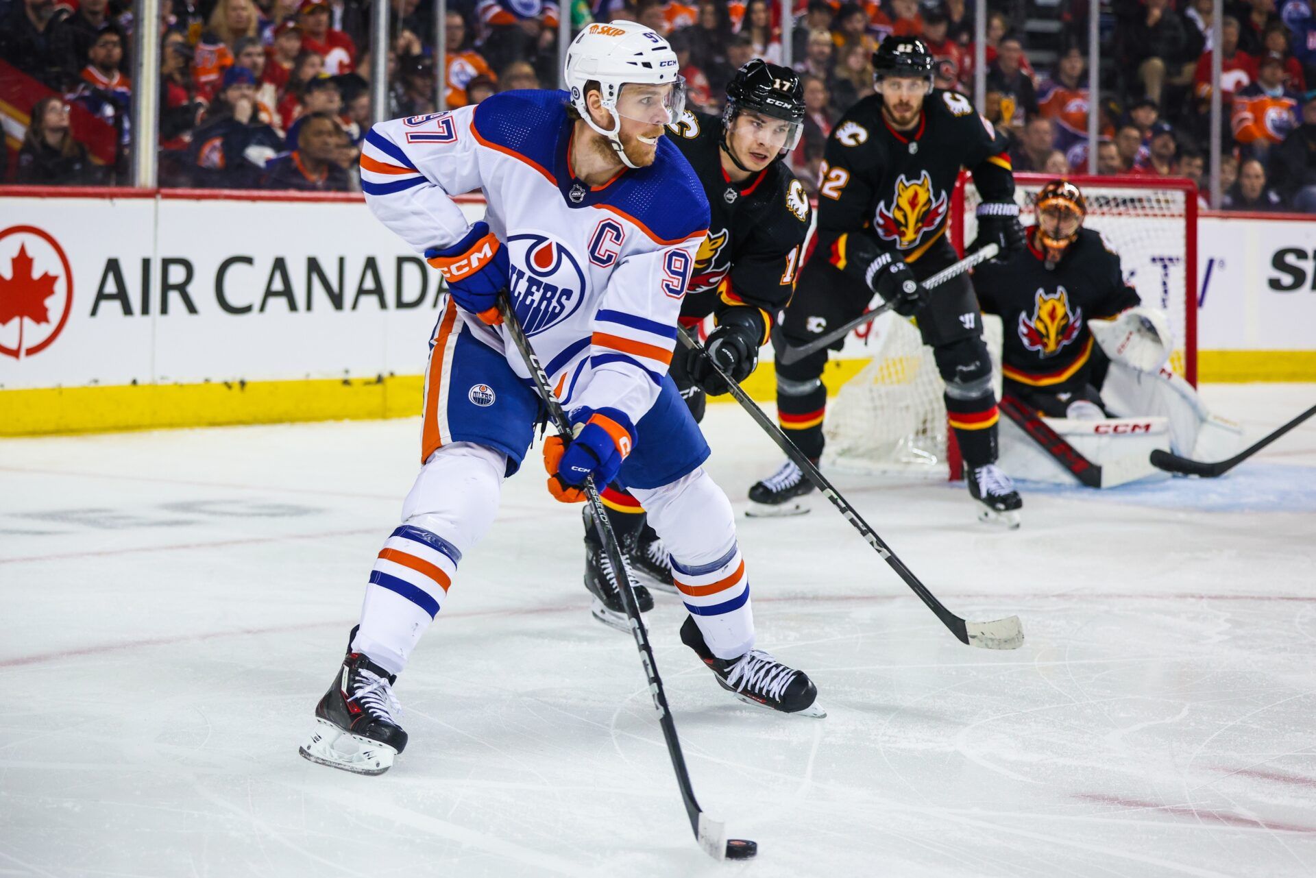 Edmonton Oilers center Connor McDavid (97) controls the puck against the Calgary Flames during the first period at Scotiabank Saddledome.