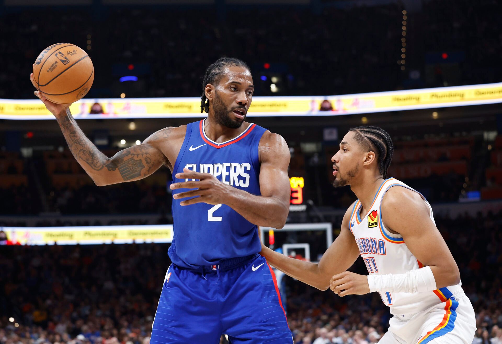 LA Clippers forward Kawhi Leonard (2) moves the ball against Oklahoma City Thunder guard Aaron Wiggins (21) during the second half at Paycom Center.