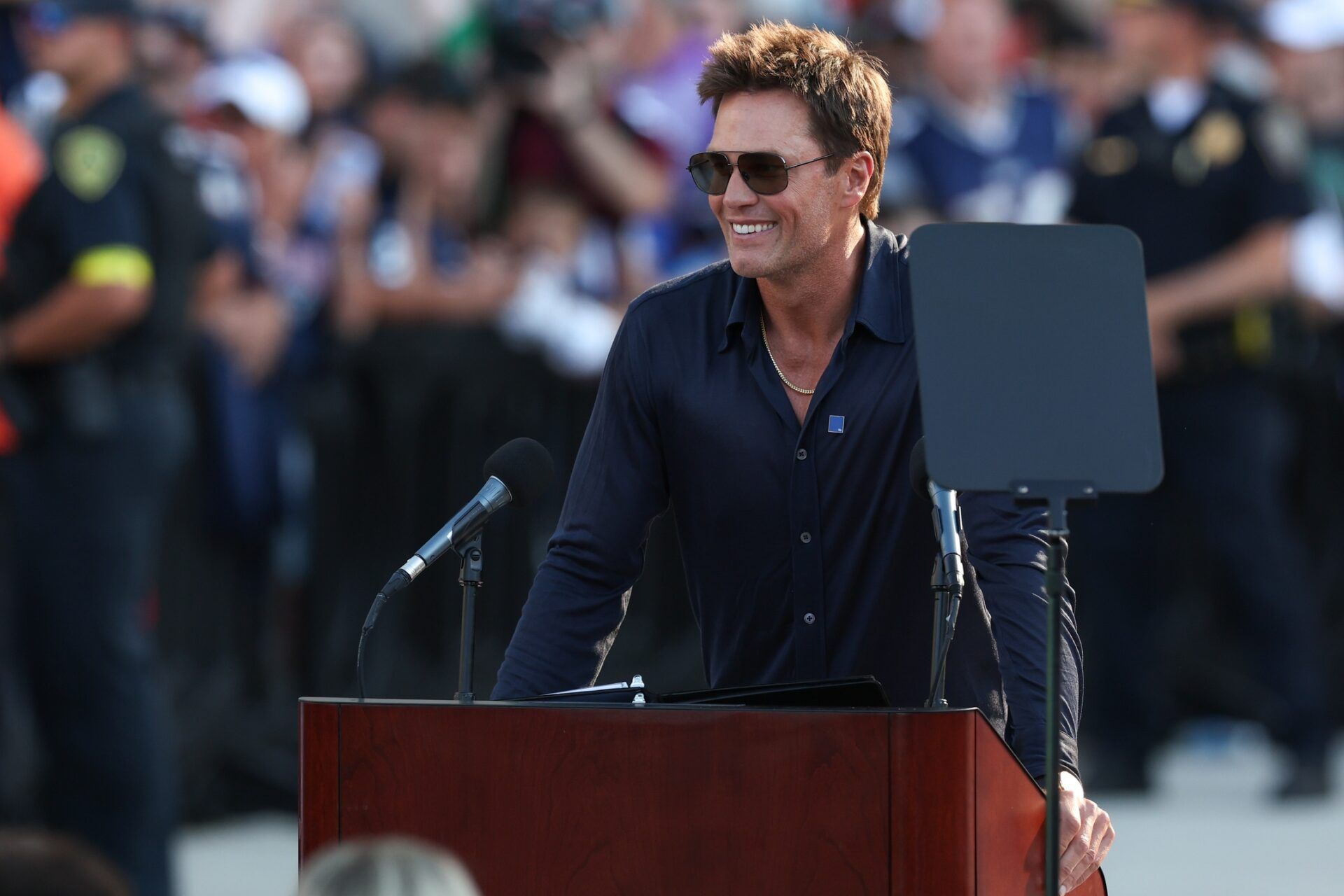 Retired New England Patriot Hall of Famer Tom Brady speaks during a statue unveiling before a game against the Washington Commanders at Gillette Stadium.