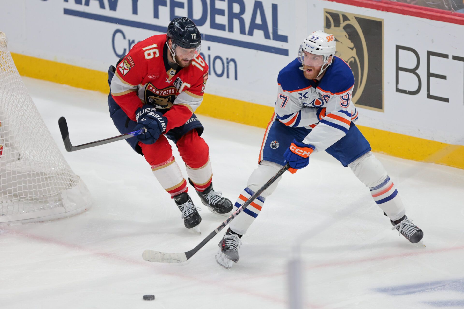 Edmonton Oilers center Connor McDavid (97) passes the puck away from Florida Panthers center Aleksander Barkov (16) during the third period in game six of the 2025 Stanley Cup Final at Amerant Bank Arena.