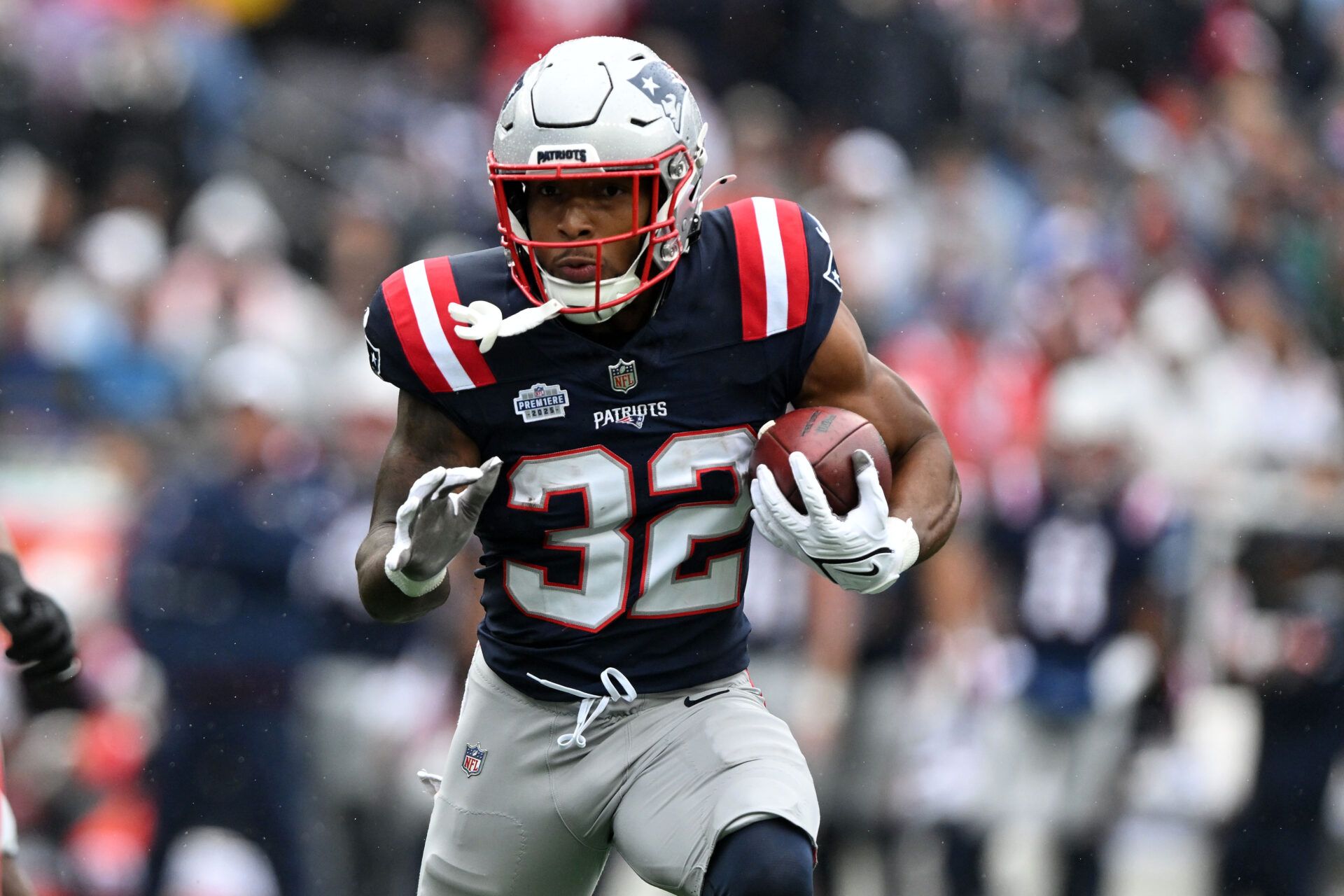 New England Patriots running back TreVeyon Henderson (32) rushes the ball against the Las Vegas Raiders in the first half at Gillette Stadium.