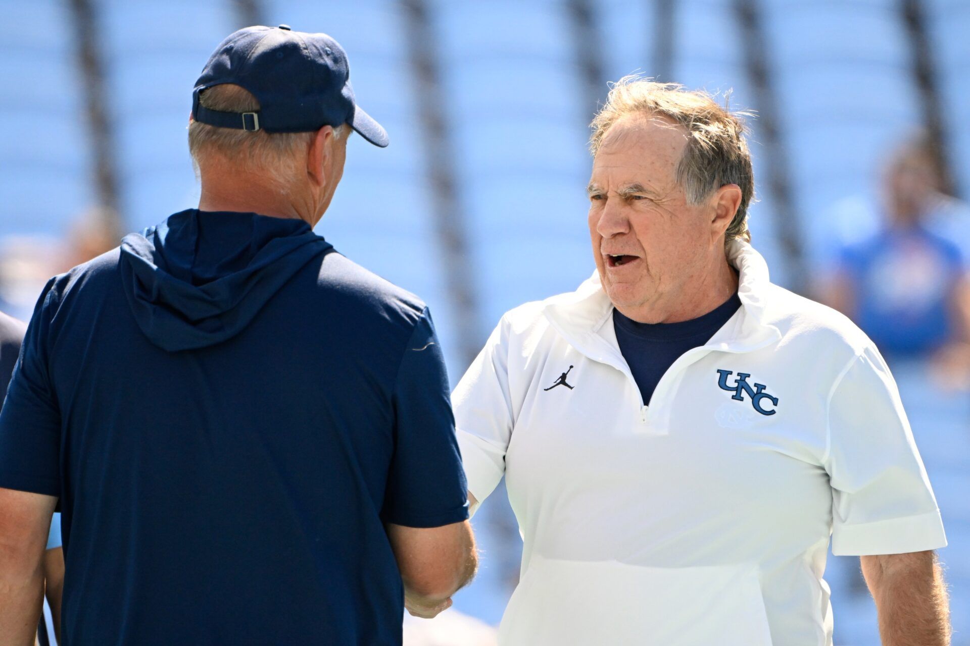 North Carolina Tar Heels head coach Bill Belichick greets Richmond Spiders head coach Russ Huesman before the game at Kenan Stadium.