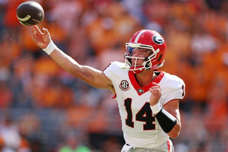 Georgia Bulldogs quarterback Gunner Stockton (14) throws a pass during the second half against the Tennessee Volunteers at Neyland Stadium.