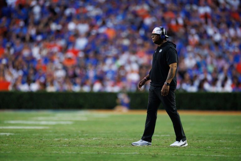 Florida Gators associate head coach for running backs Jabbar Juluke walks on the field against the Long Island Sharks during the first half at Ben Hill Griffin Stadium.