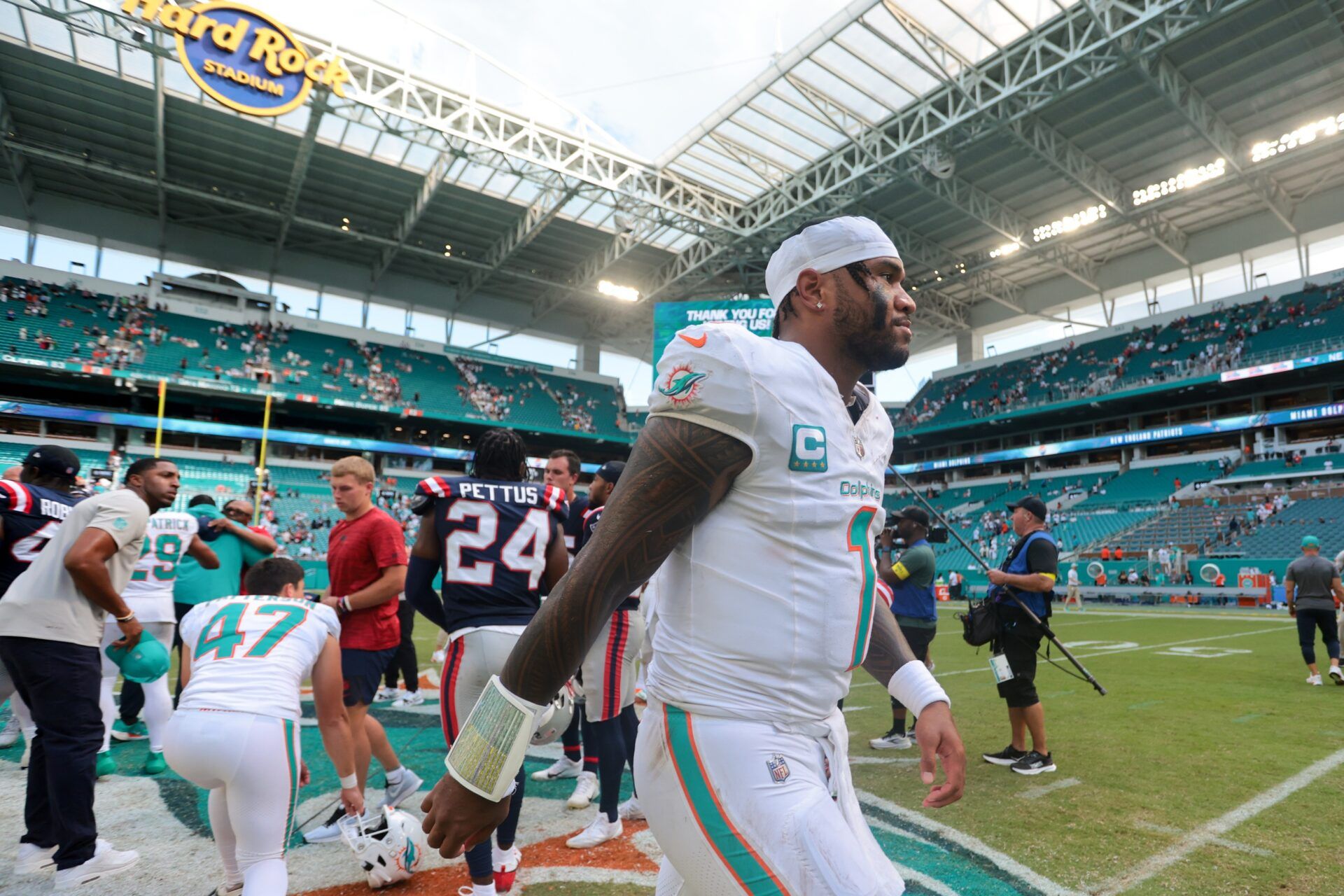 Miami Dolphins quarterback Tua Tagovailoa (1) walks off the field after the game against the New England Patriots at Hard Rock Stadium.