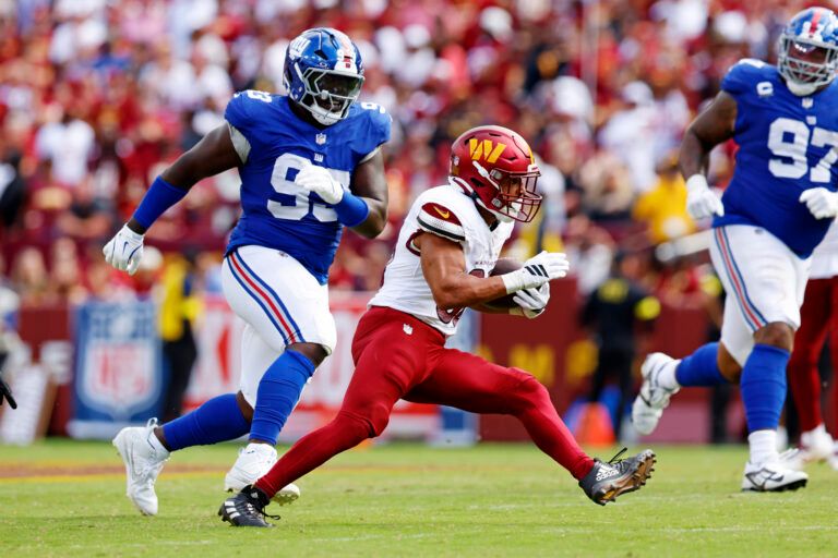 Washington Commanders running back Austin Ekeler (30) makes a run against the New York Giants during the fourth quarter at Northwest Stadium.
