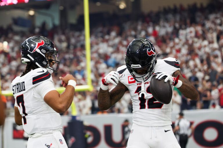 Houston Texans wide receiver Nico Collins (12) celebrates with Houston Texans quarterback C.J. Stroud (7) after scoring a touchdown during the first quarter against the Tampa Bay Buccaneers at NRG Stadium.