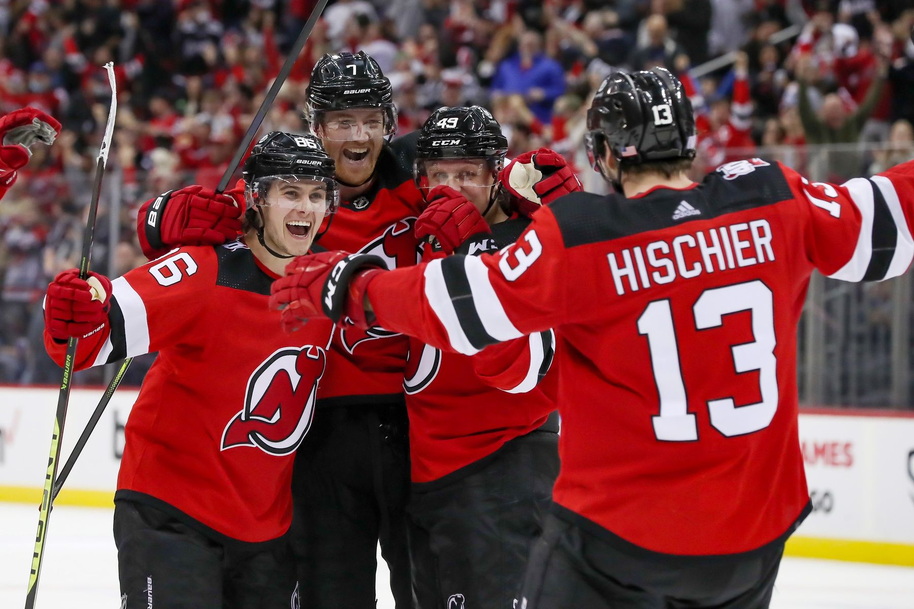 (Editors Notes: Caption Correction) New Jersey Devils center Nico Hischier (13) celebrates with center Jack Hughes (86), defenseman Dougie Hamilton (7), and left wing Fabian Zetterlund (49) after scoring the game winning goal in overtime against the Ottawa Senators at Prudential Center.