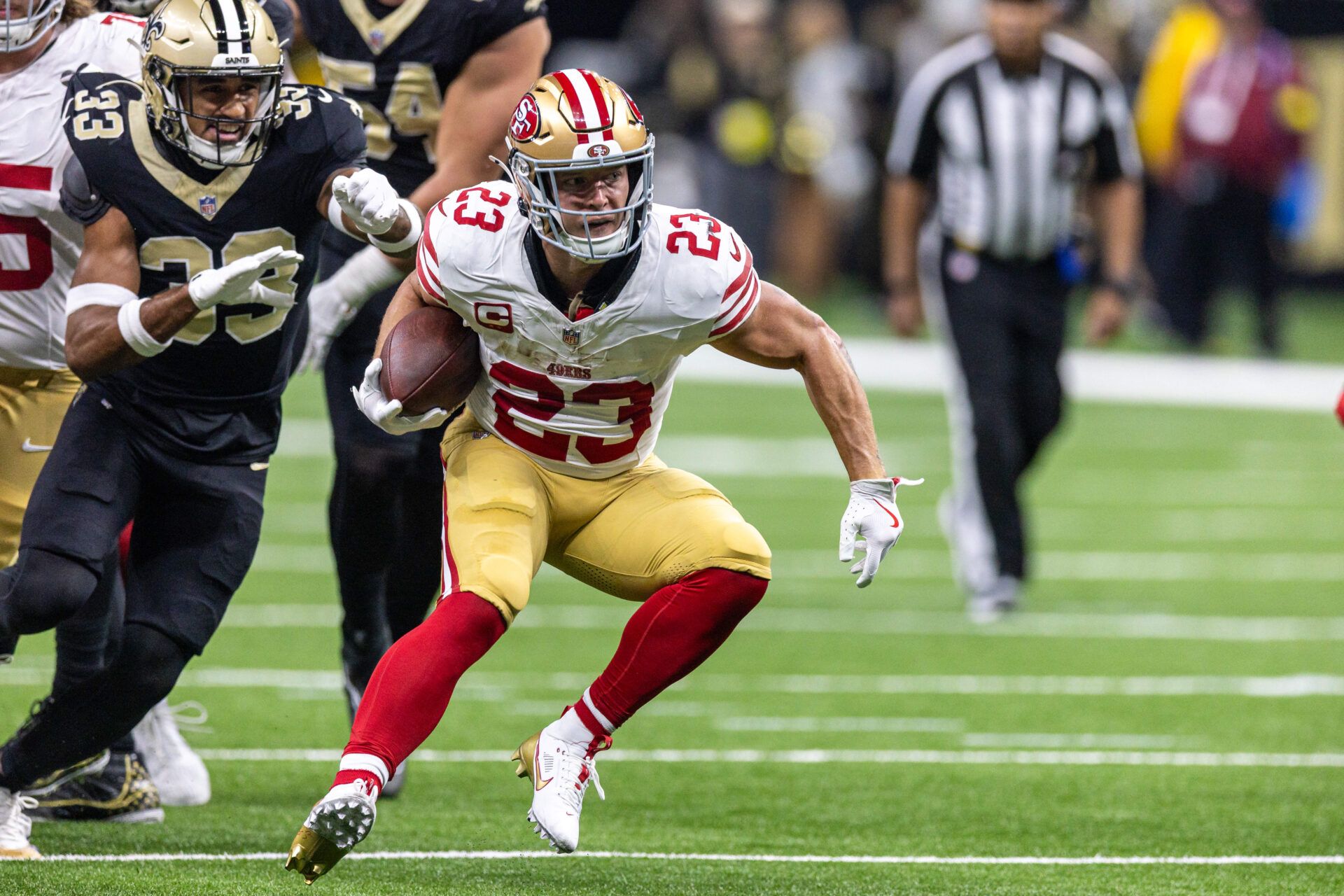 San Francisco 49ers running back Christian McCaffrey (23) runs against New Orleans Saints safety Jonas Sanker (33) during the first half at Caesars Superdome.