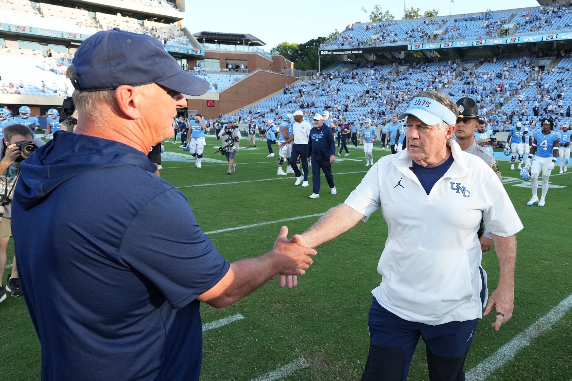 Richmond Spiders head coach Russ Huesman with North Carolina Tar Heels head coach Bill Belichick after the game at Kenan Stadium.