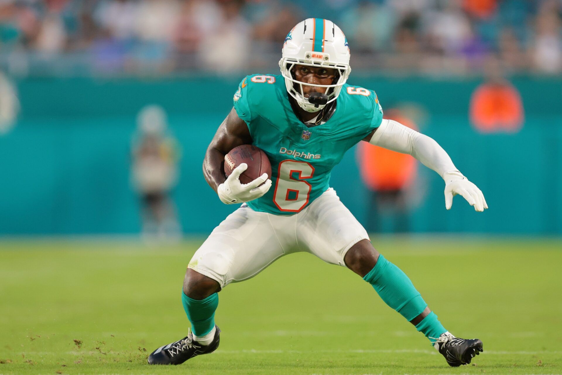 Miami Dolphins wide receiver Malik Washington (6) runs with the football against the Jacksonville Jaguars during the second quarter at Hard Rock Stadium.