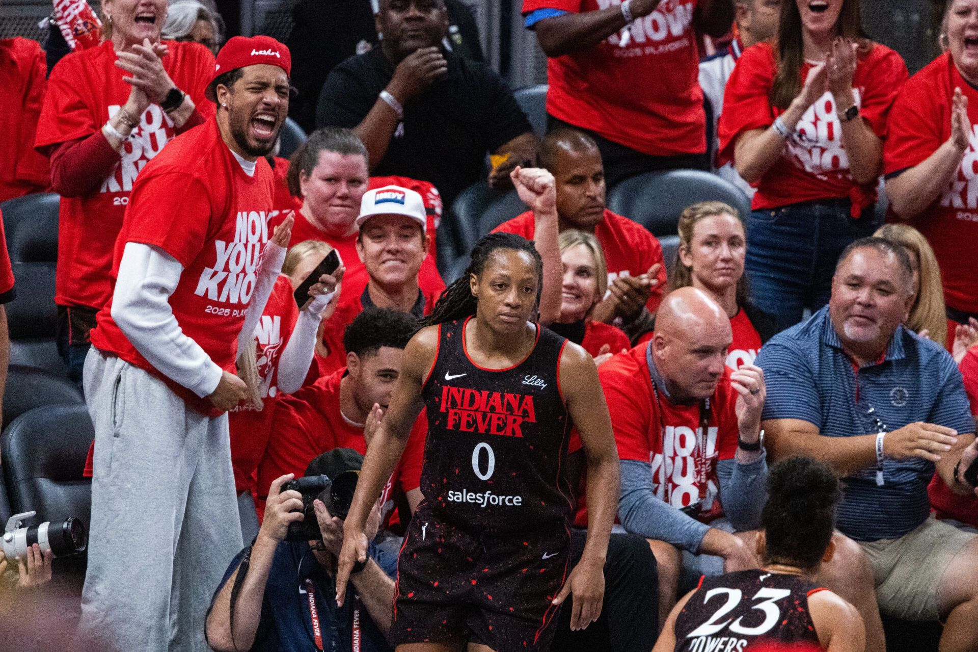 Indiana Fever guard Kelsey Mitchell (0) celebrates a made basket with Indiana Pacers guard Tyrese Haliburton (0) during game two of round one against the Atlanta Dream for the 2025 WNBA Playoffs at Gainbridge Fieldhouse.