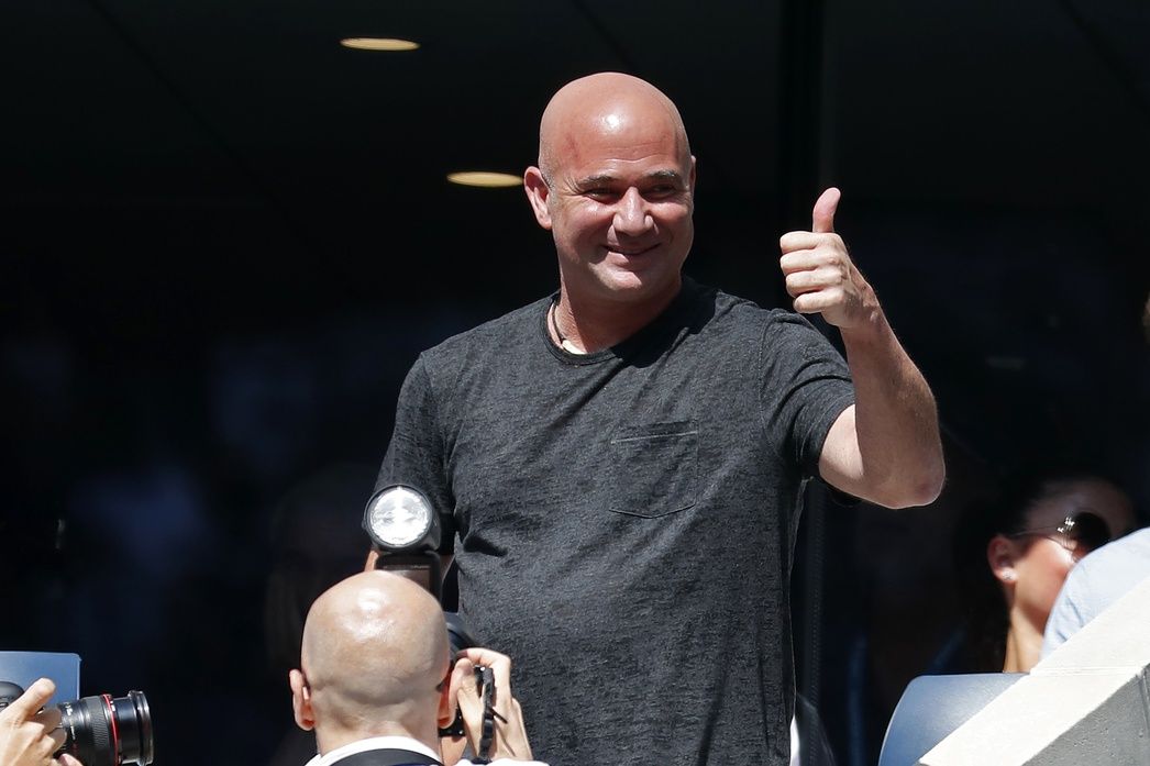 International Tennis Hall of Famer and former US Open champion Andre Agassi acknowledges the crowd during a changeover in the match between Marin Cilic of Croatia and Kei Nishikori of Japan (both not pictured) in a quarter-final match on day ten of the 2018 U.S. Open tennis tournament at USTA Billie Jean King National Tennis Center.