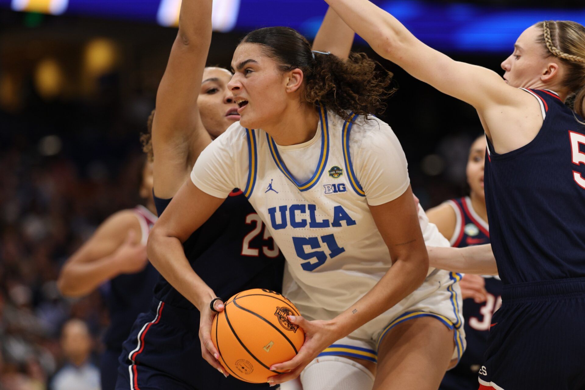 Connecticut Huskies forward Ice Brady (25) defends against UCLA Bruins center Lauren Betts (51) during second quarter in a semifinal of the women's 2025 NCAA tournament at Amalie Arena.