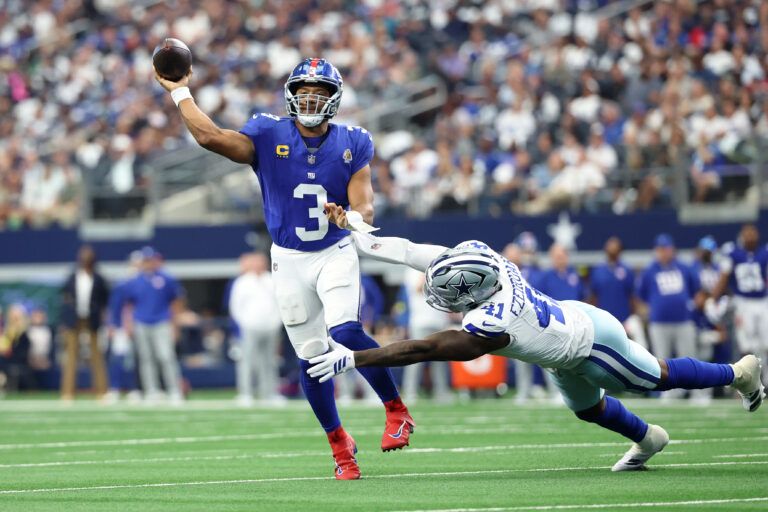 New York Giants quarterback Russell Wilson (3) passes the ball against Dallas Cowboys defensive end Donovan Ezeiruaku (41) during the third quarter at AT&T Stadium.