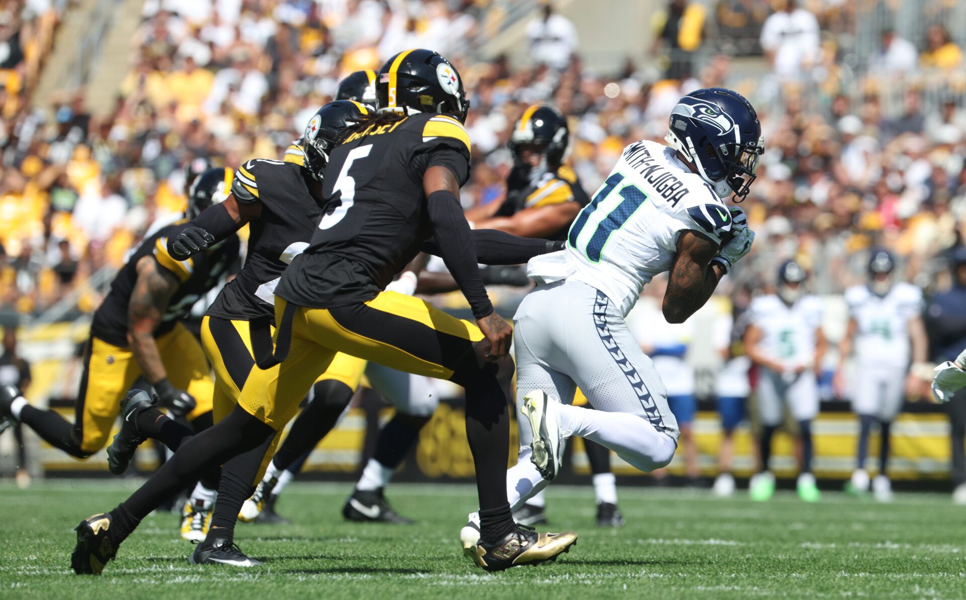 Seattle Seahawks wide receiver Jaxon Smith-Njigba (11) runs after catch against Pittsburgh Steelers cornerback Jalen Ramsey (5) during the first quarter t Acrisure Stadium.