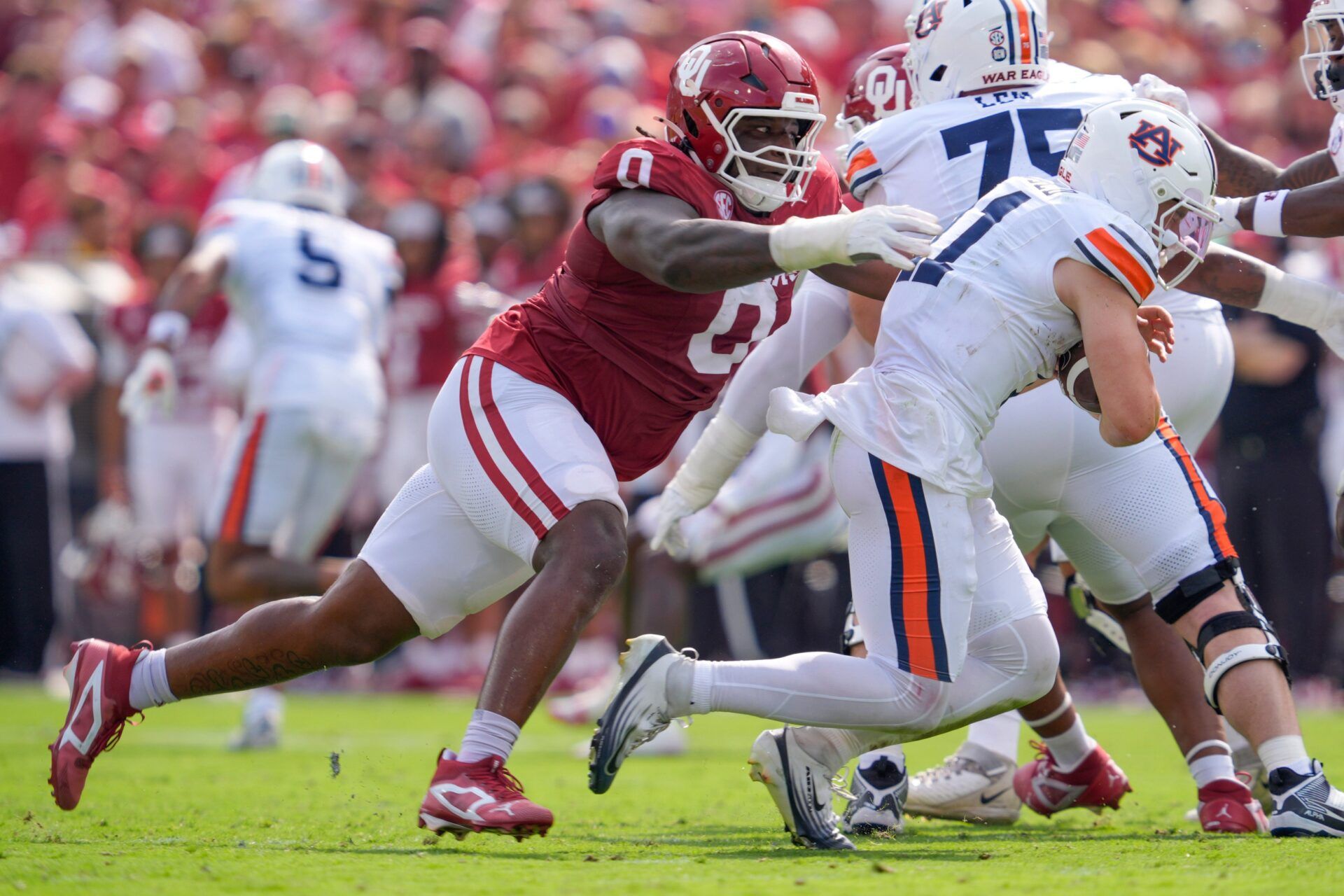 Oklahoma Sooners defensive lineman David Stone (0) brings down Auburn Tigers quarterback Jackson Arnold (11) during a college football game between the University of Oklahoma Sooners (OU) and the Auburn Tigers at Gaylord Family Ð Oklahoma Memorial Stadium in Norman, Okla., Saturday,Sept. 20, 2025. Oklahoma won 24-17.