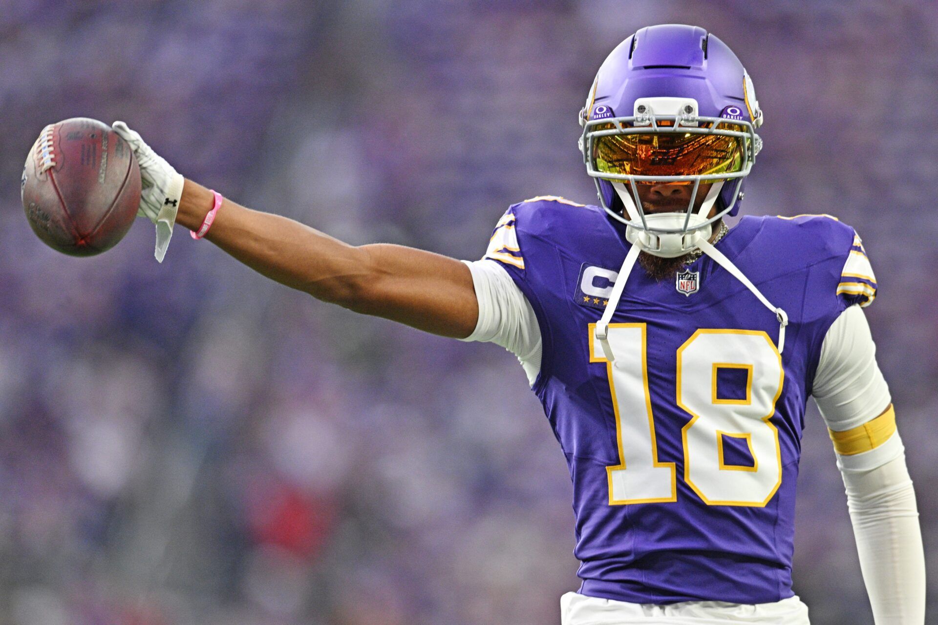 Minnesota Vikings wide receiver Justin Jefferson (18) holds out the ball before the game against the Atlanta Falcons at U.S. Bank Stadium.