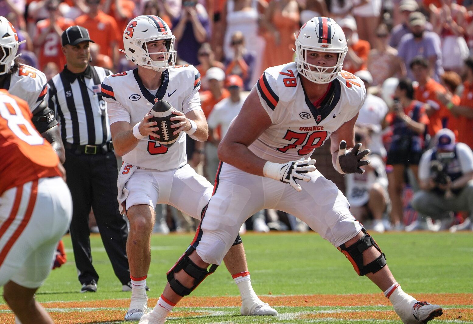 Syracuse Orange quarterback Steve Angeli (9) takes a snap near offensive lineman Joe Cruz (78) playing the Clemson Tigers during the first quarter at Memorial Stadium.