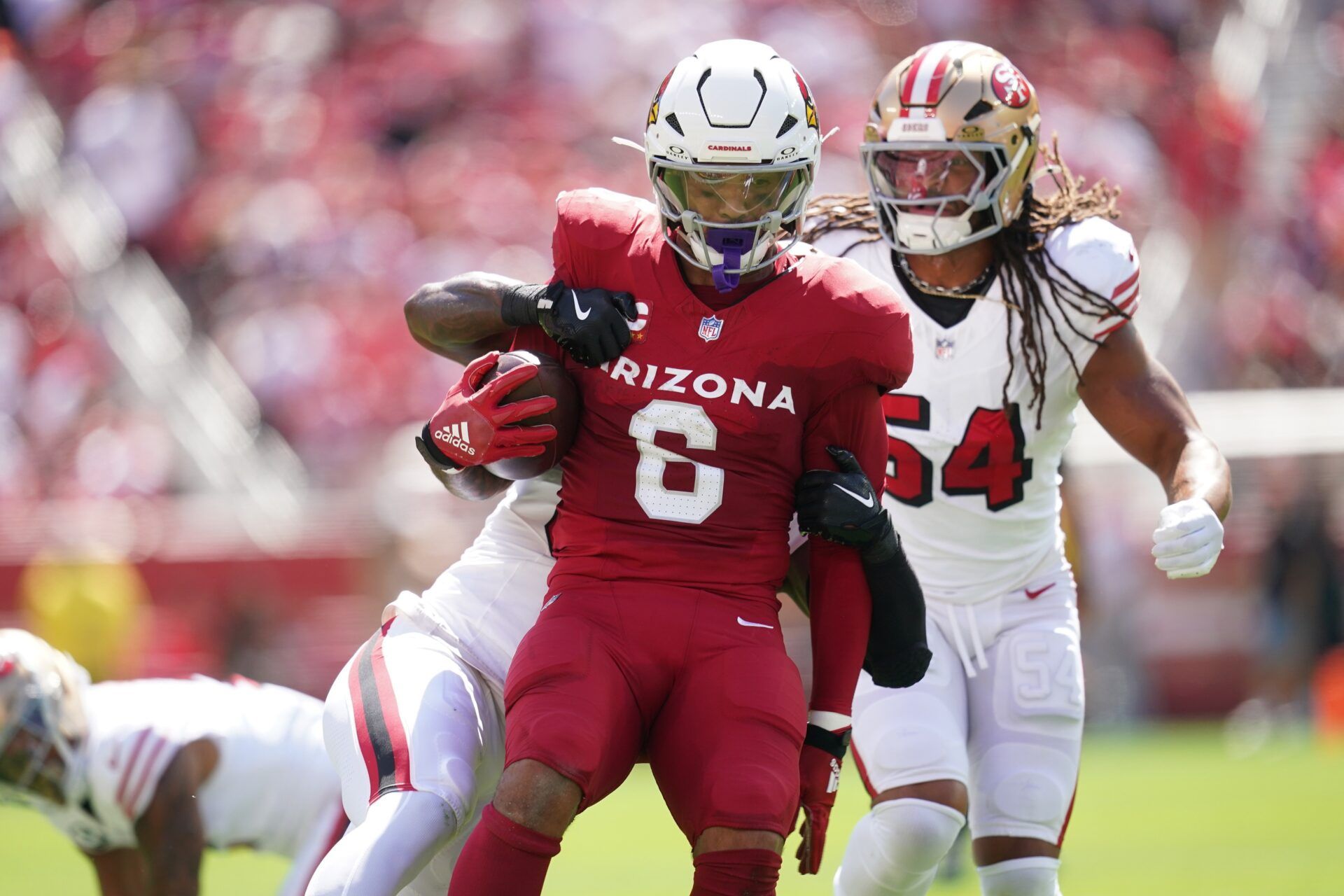 Arizona Cardinals running back James Conner (6) is tackled by San Francisco 49ers linebacker Dee Winters (53) during the first half at Levi's Stadium.