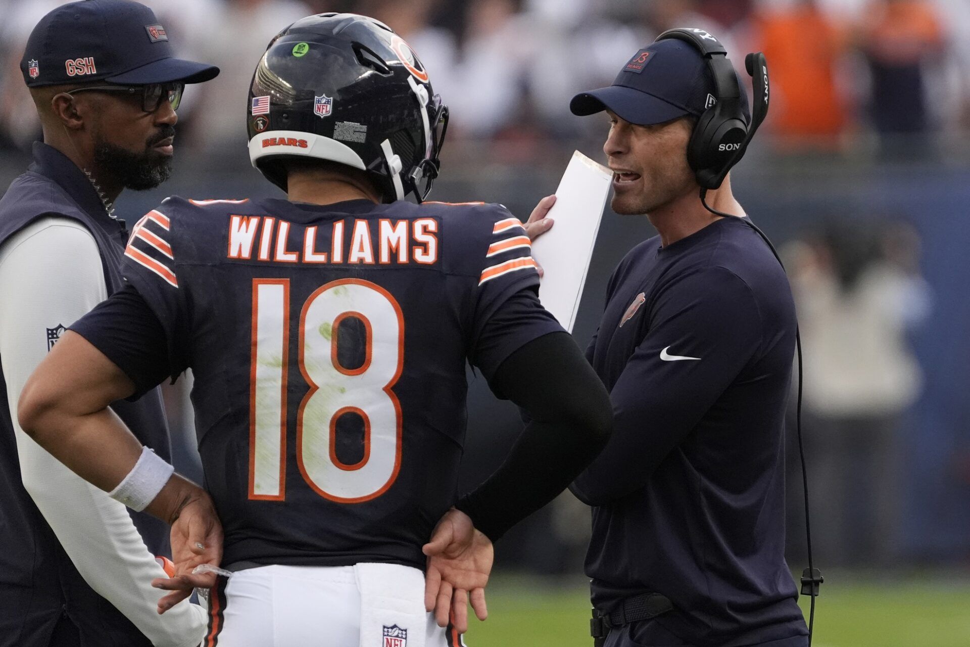 Chicago Bears head coach Ben Johnson talks with quarterback Caleb Williams (18) against the Dallas Cowboys during the second half at Soldier Field.