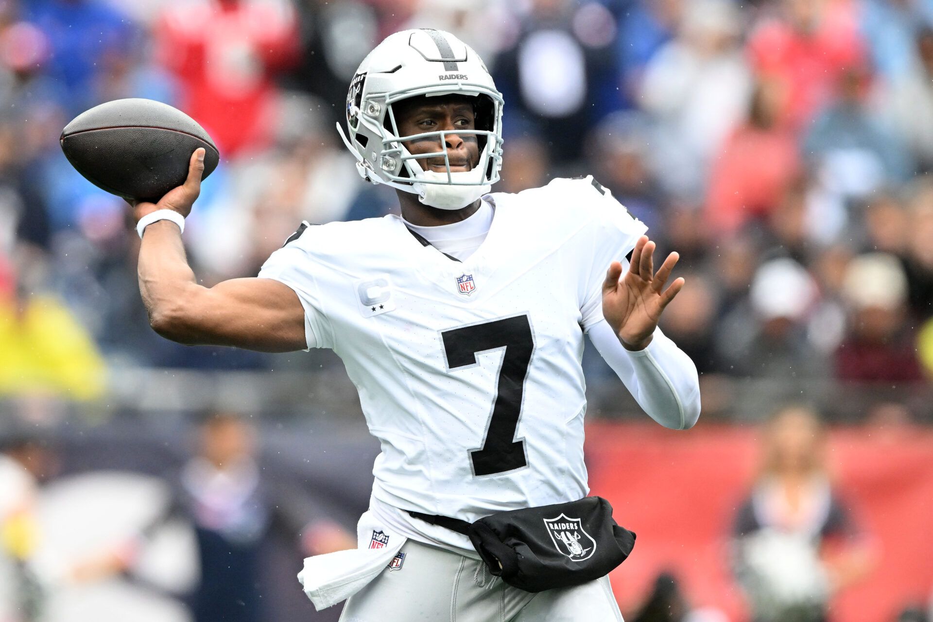 Las Vegas Raiders quarterback Geno Smith (7) drops back to pass against the New England Patriots during the first half at Gillette Stadium.