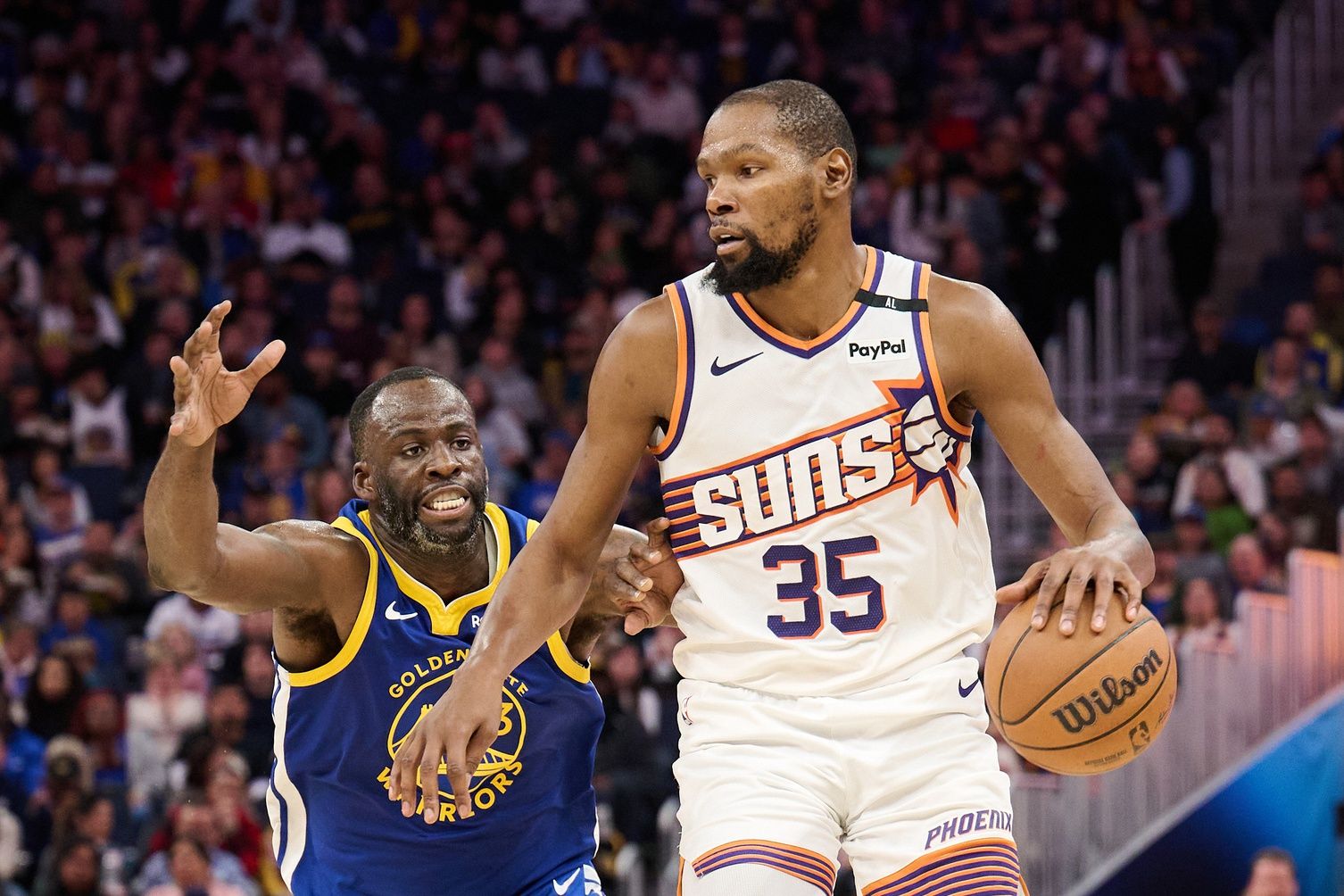 Phoenix Suns forward Kevin Durant (35) controls the ball against Golden State Warriors forward Draymond Green (23) during the third quarter at Chase Center.