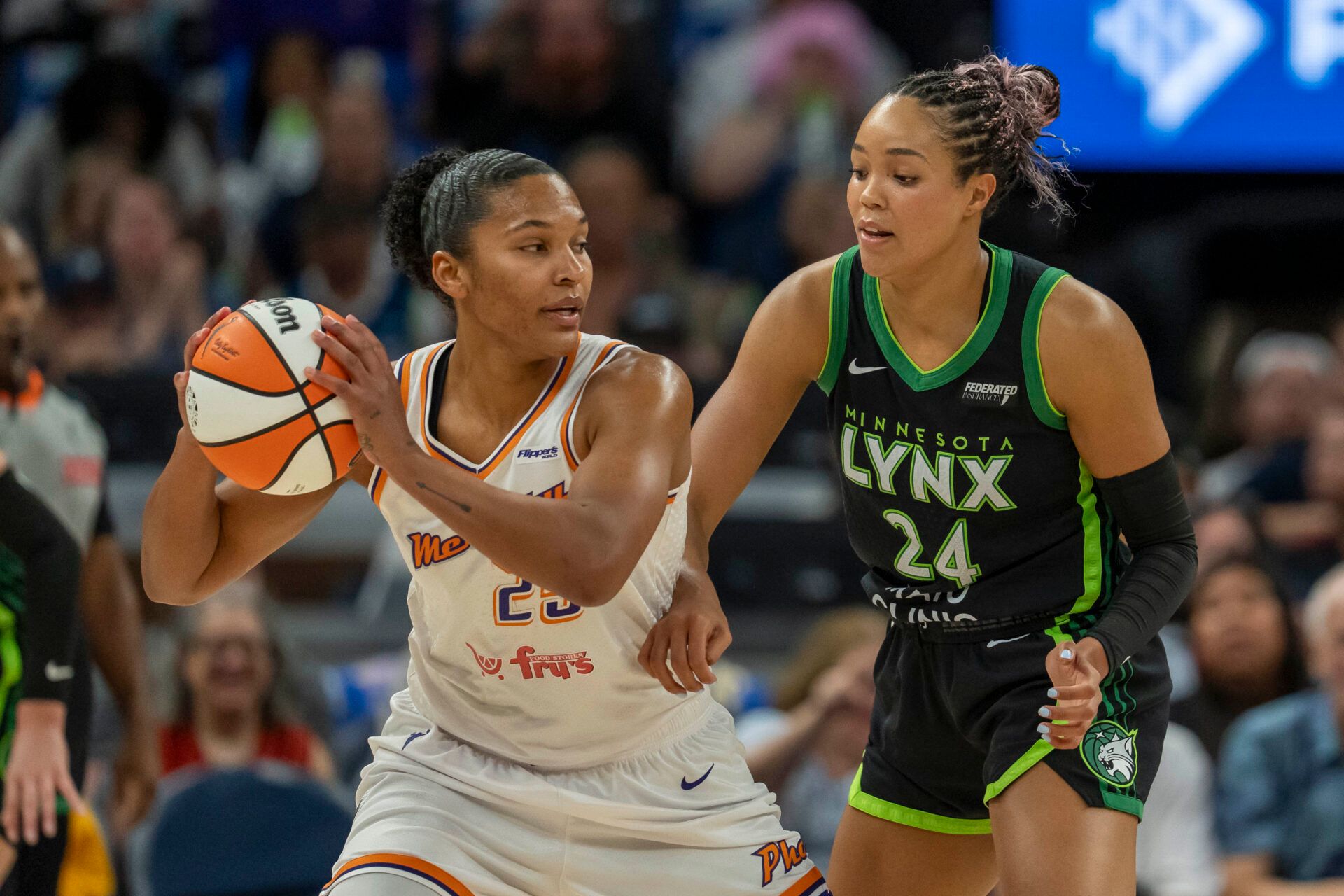 Phoenix Mercury forward Alyssa Thomas (25) holds the ball as Minnesota Lynx forward Napheesa Collier (24) plays defense in the first half during game one of the second round for the 2025 WNBA Playoffs at Target Center.