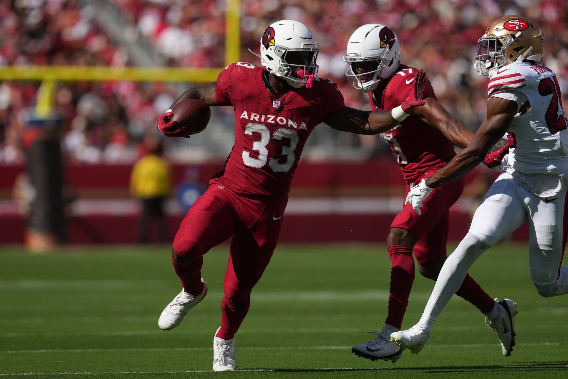 Arizona Cardinals running back Trey Benson (33) carries the ball as San Francisco 49ers safety Jason Pinnock (25) defends during the second half at Levi's Stadium.