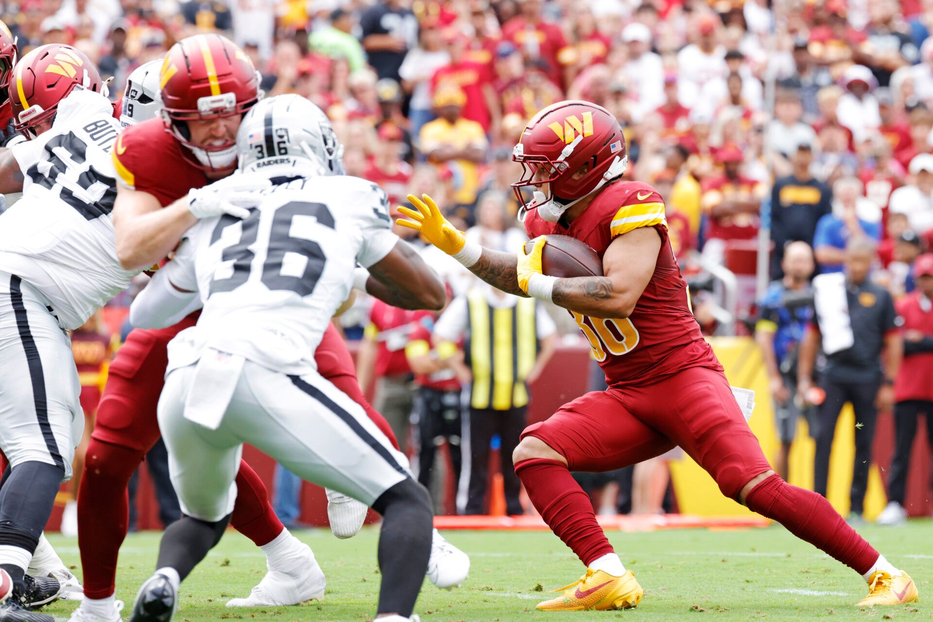 Washington Commanders running back Chris Rodriguez Jr. (36) runs the ball during the first half against the Las Vegas Raiders at Northwest Stadium.