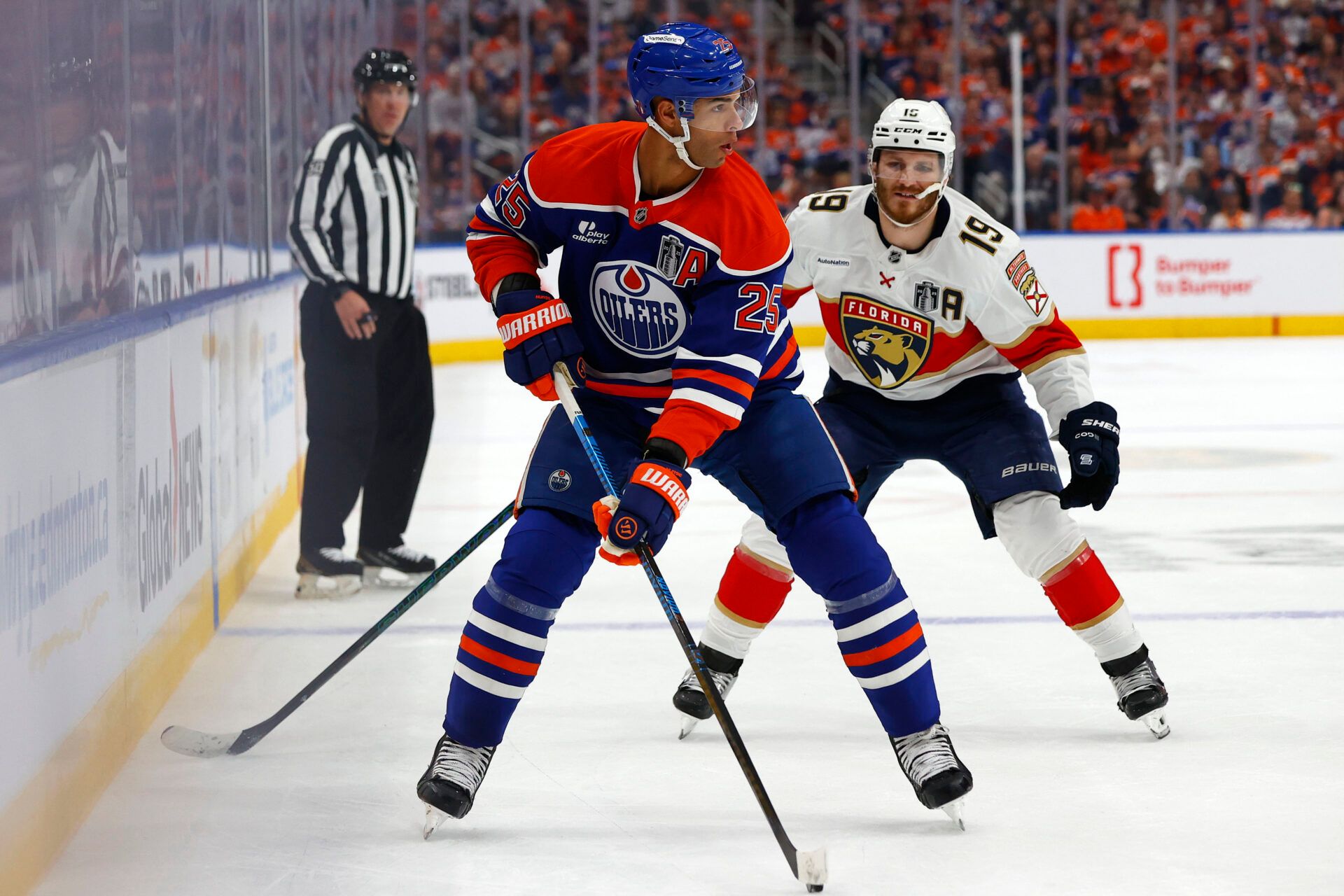 Edmonton Oilers defenseman Darnell Nurse (25) skates with the puck past Florida Panthers left wing Matthew Tkachuk (19) during the first period in game one of the 2025 Stanley Cup Final at Rogers Place.