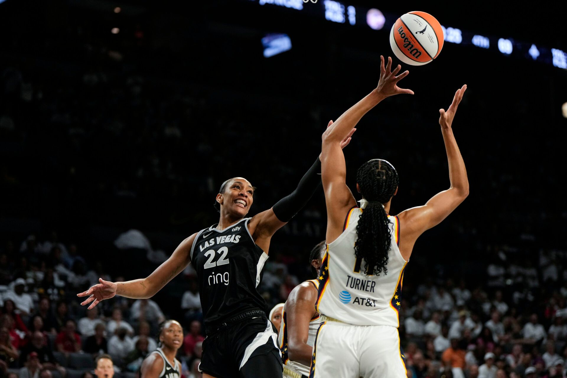 Las Vegas Aces center A'ja Wilson (22) reaches for the ball against Indiana Fever forward Brianna Turner (11) during the fourth quarter in game one of the second round for the 2025 WNBA Playoffs at Michelob Ultra Arena.