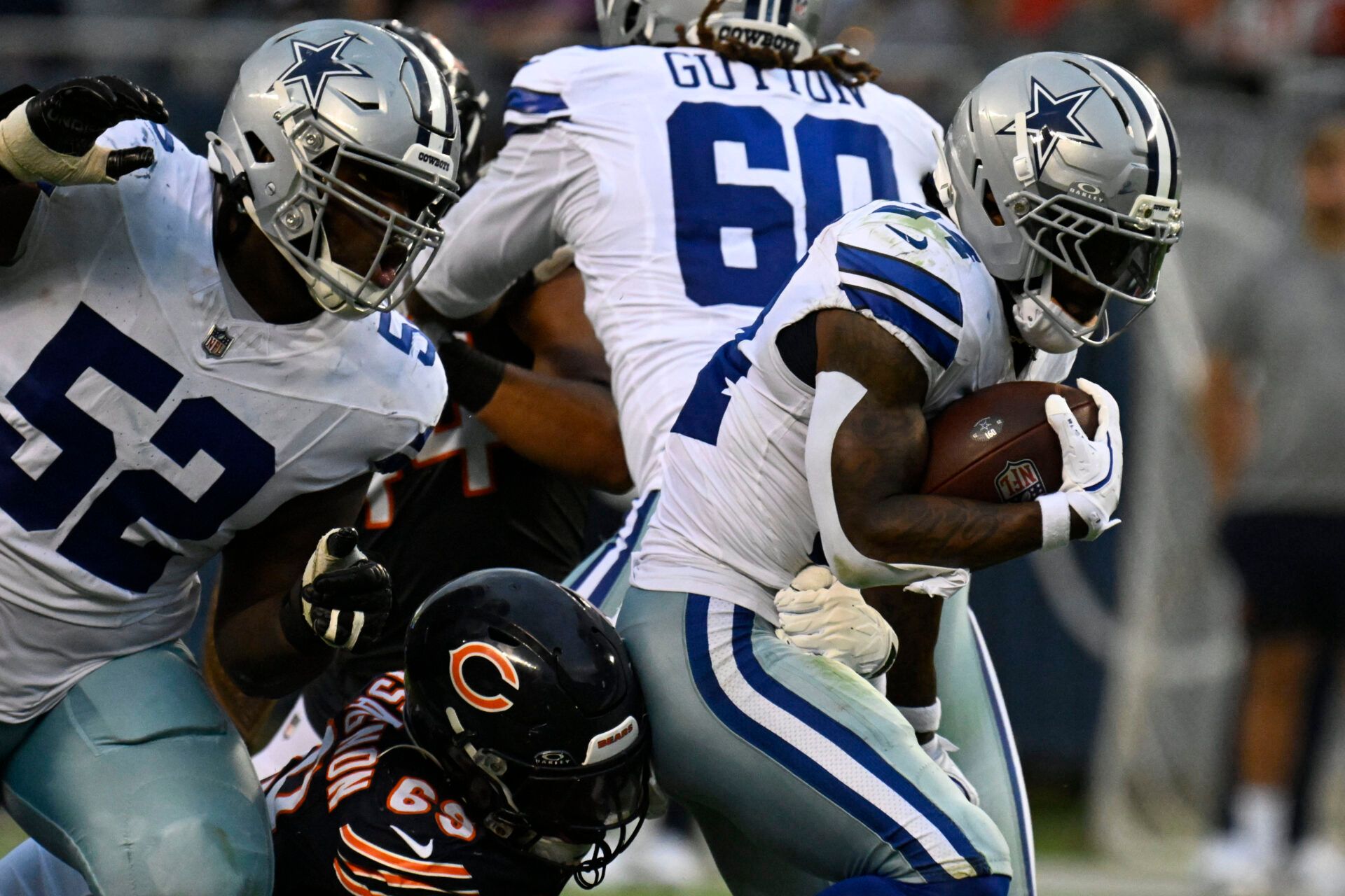 Dallas Cowboys running back Miles Sanders (24) rushes the ball against the Chicago Bears during the second half at Soldier Field.
