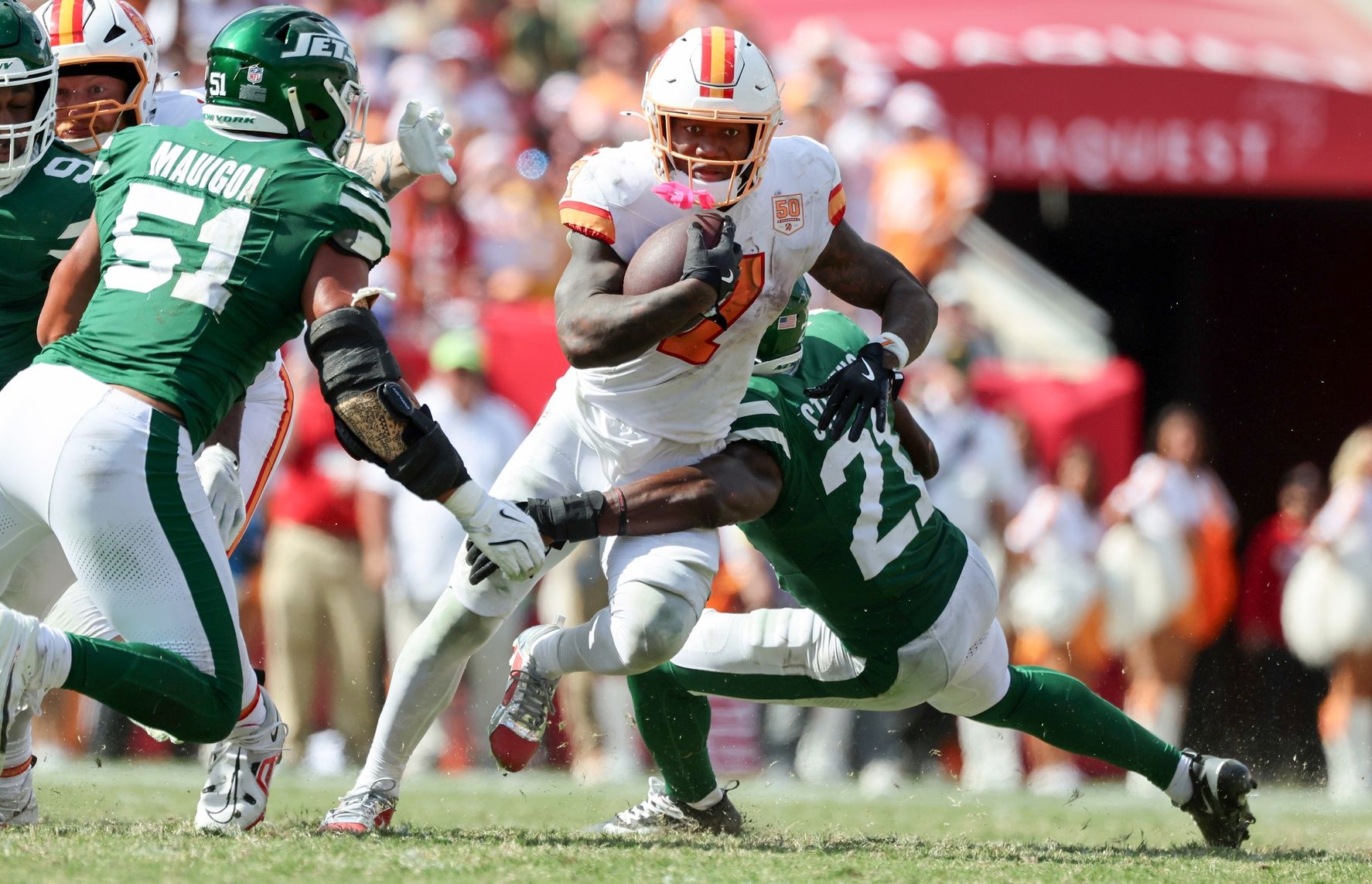 Tampa Bay Buccaneers running back Bucky Irving (7) runs with the ball as New York Jets cornerback Brandon Stephens (21) defends during the second half at Raymond James Stadium.