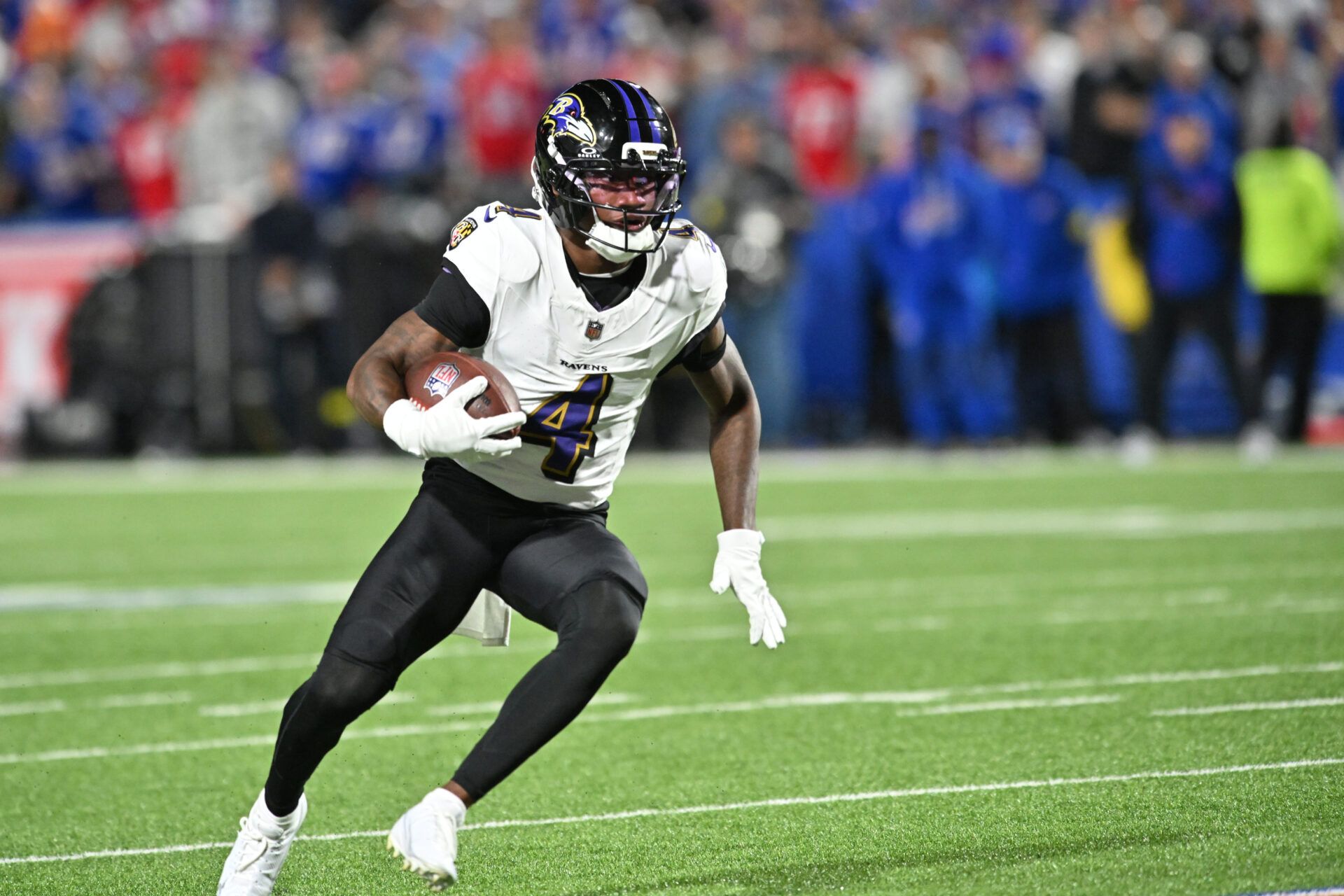 Baltimore Ravens wide receiver Zay Flowers (4) runs the ball during the first quarter against the Buffalo Bills at Highmark Stadium.