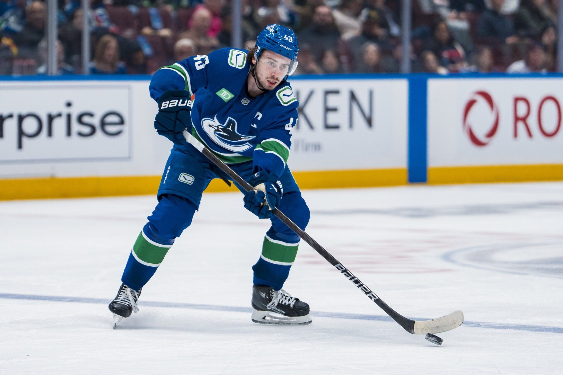 Vancouver Canucks defenseman Quinn Hughes (43) handles the puck against the Minnesota Wild in the second period at Rogers Arena.