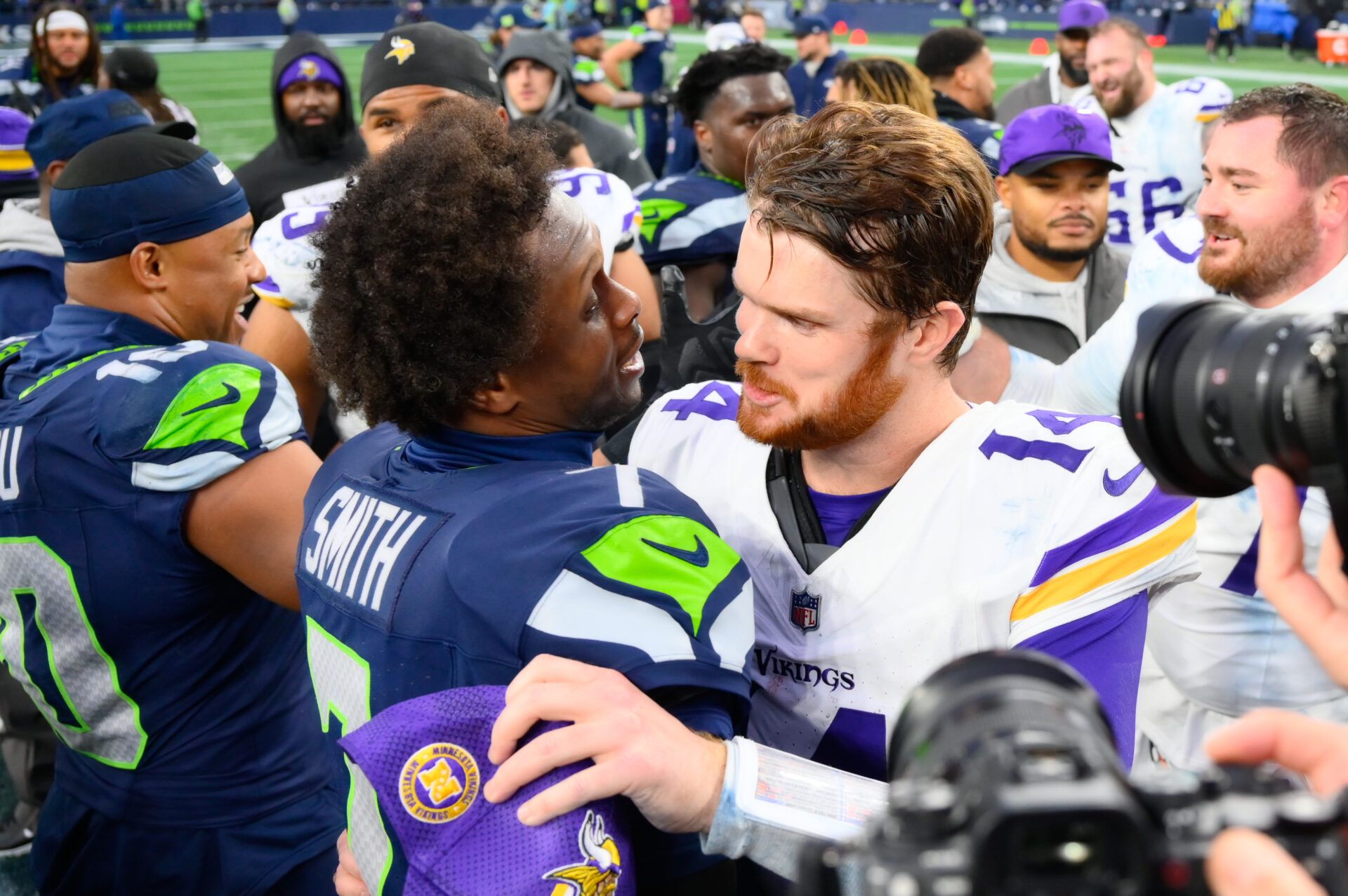 Seattle Seahawks quarterback Geno Smith (7) and Minnesota Vikings quarterback Sam Darnold (14) hug after the game at Lumen Field.
