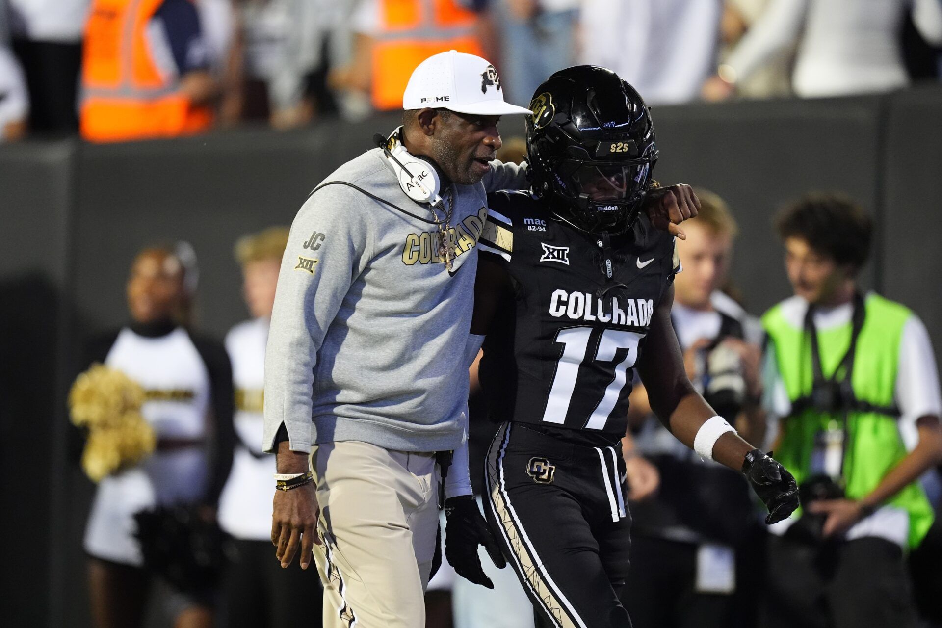 Colorado Buffaloes head coach Deion Sanders and wide receiver Isaiah Hardge (17) during the first quarter against the Wyoming Cowboys at Folsom Field.