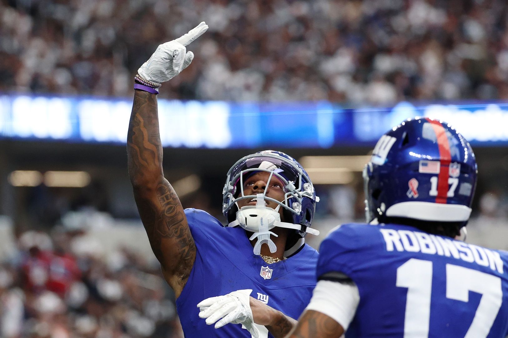 New York Giants wide receiver Malik Nabers (1) celebrates after scoring a touchdown against the Dallas Cowboys during the second quarter at AT&T Stadium.