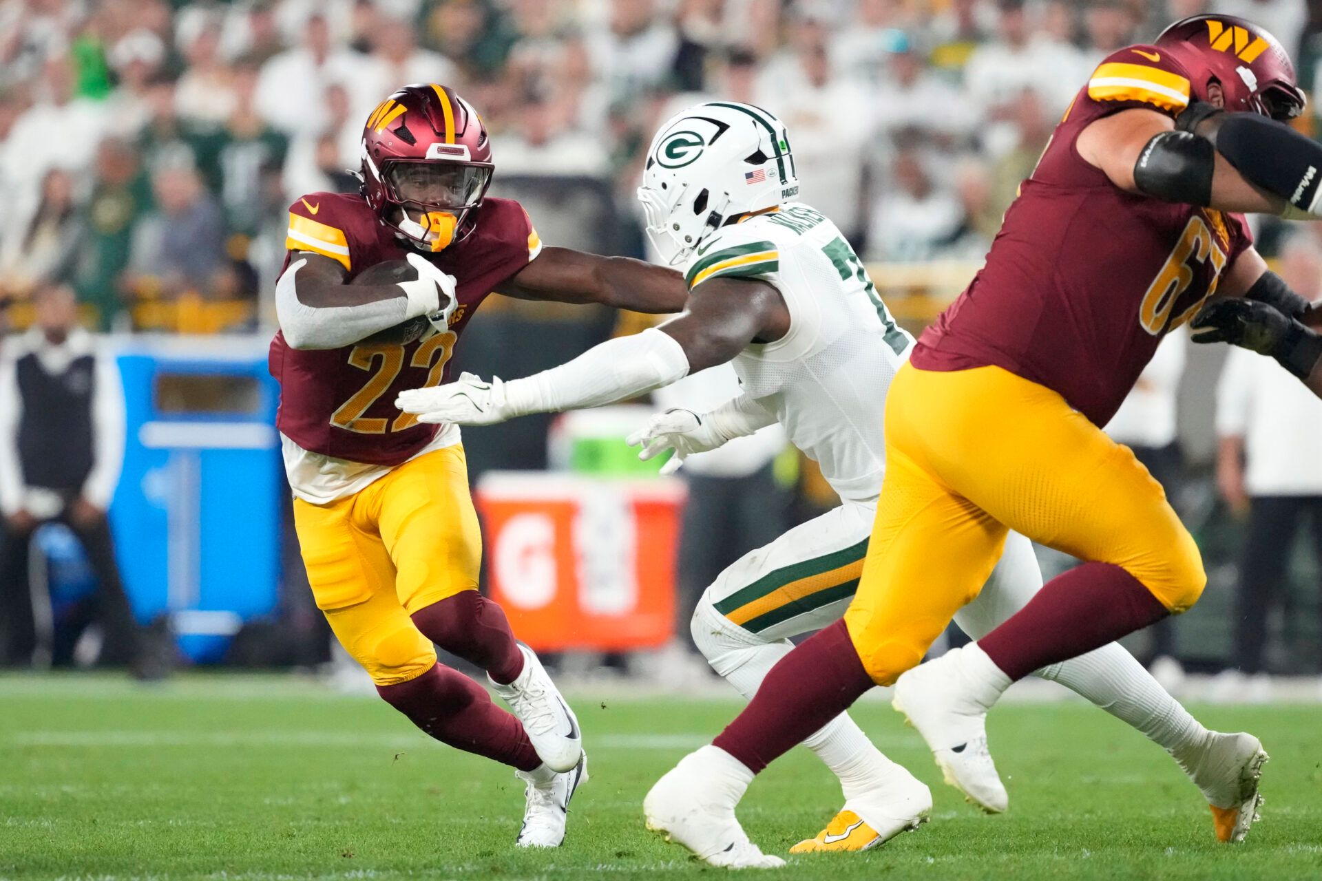 Washington Commanders running back Jacory Croskey-Merritt (22) runs against Green Bay Packers linebacker Quay Walker (7) in the third quarter at Lambeau Field.