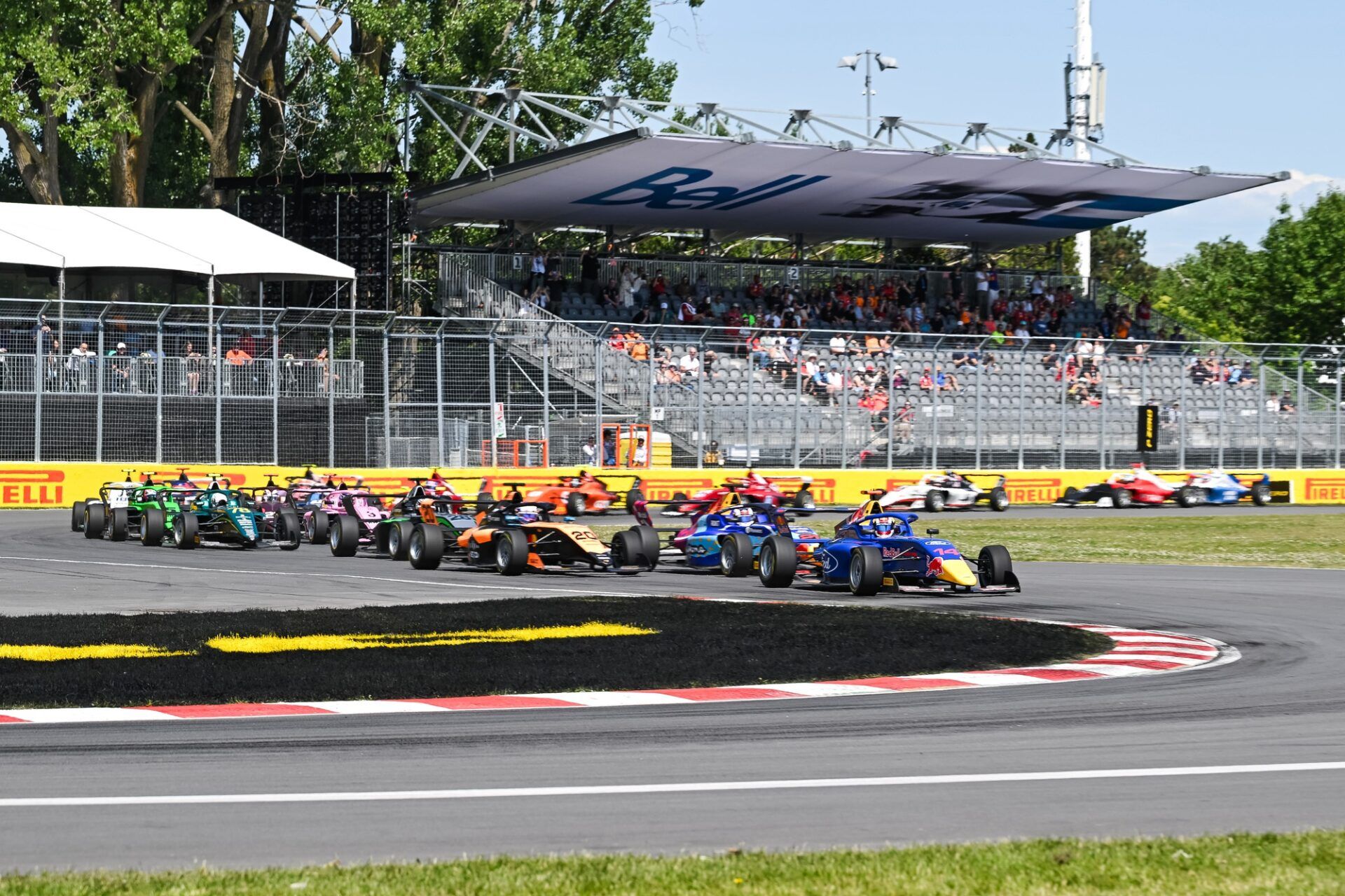 Campos Racing driver Chloe Chambers (14) leads the first lap of the F1 Academy race 3 at Circuit Gilles-Villeneuve.