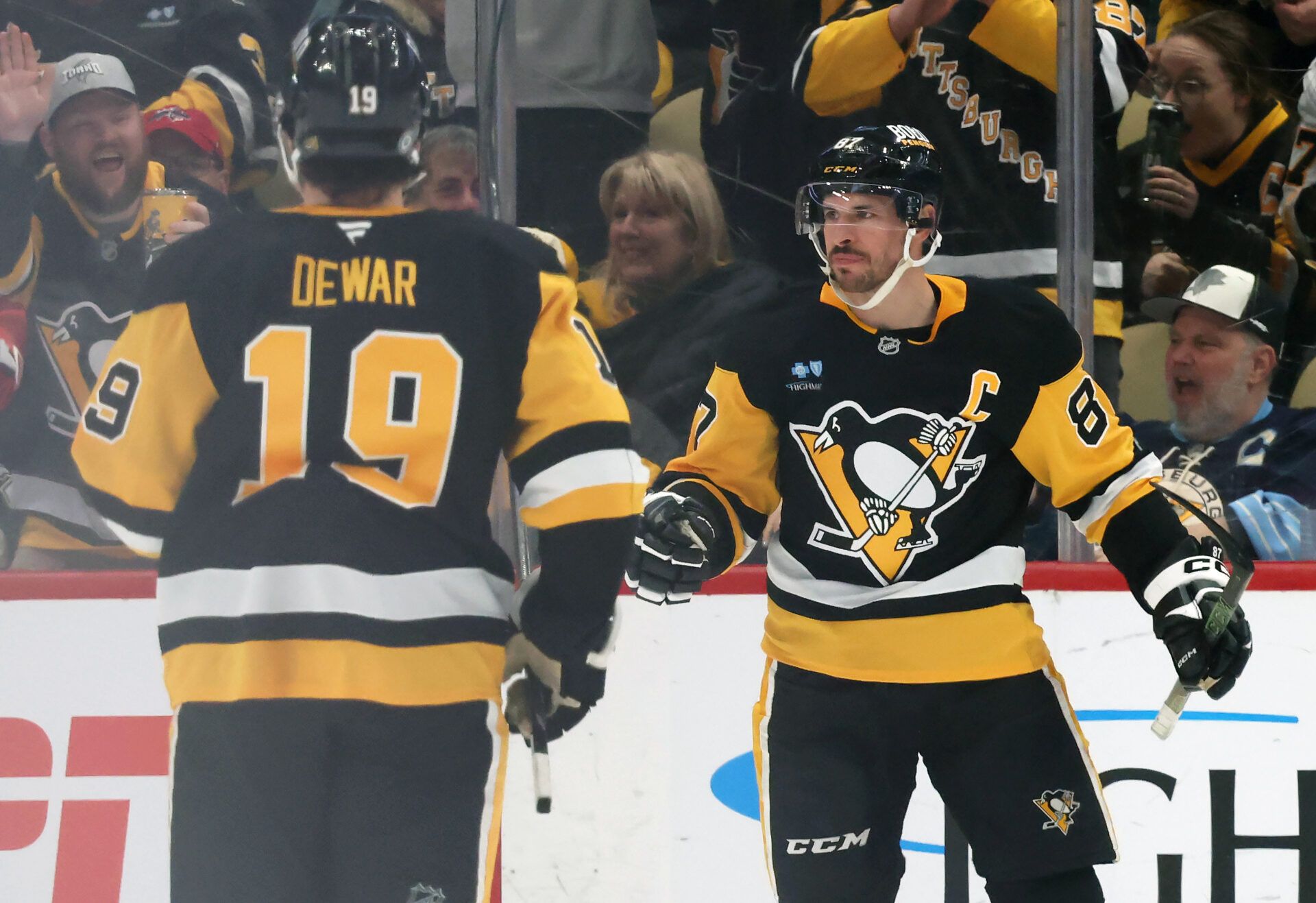 Pittsburgh Penguins center Sidney Crosby (87) reacts with center Connor Dewar (19) after Crosby scored a goal against the Washington Capitals during the second period at PPG Paints Arena.