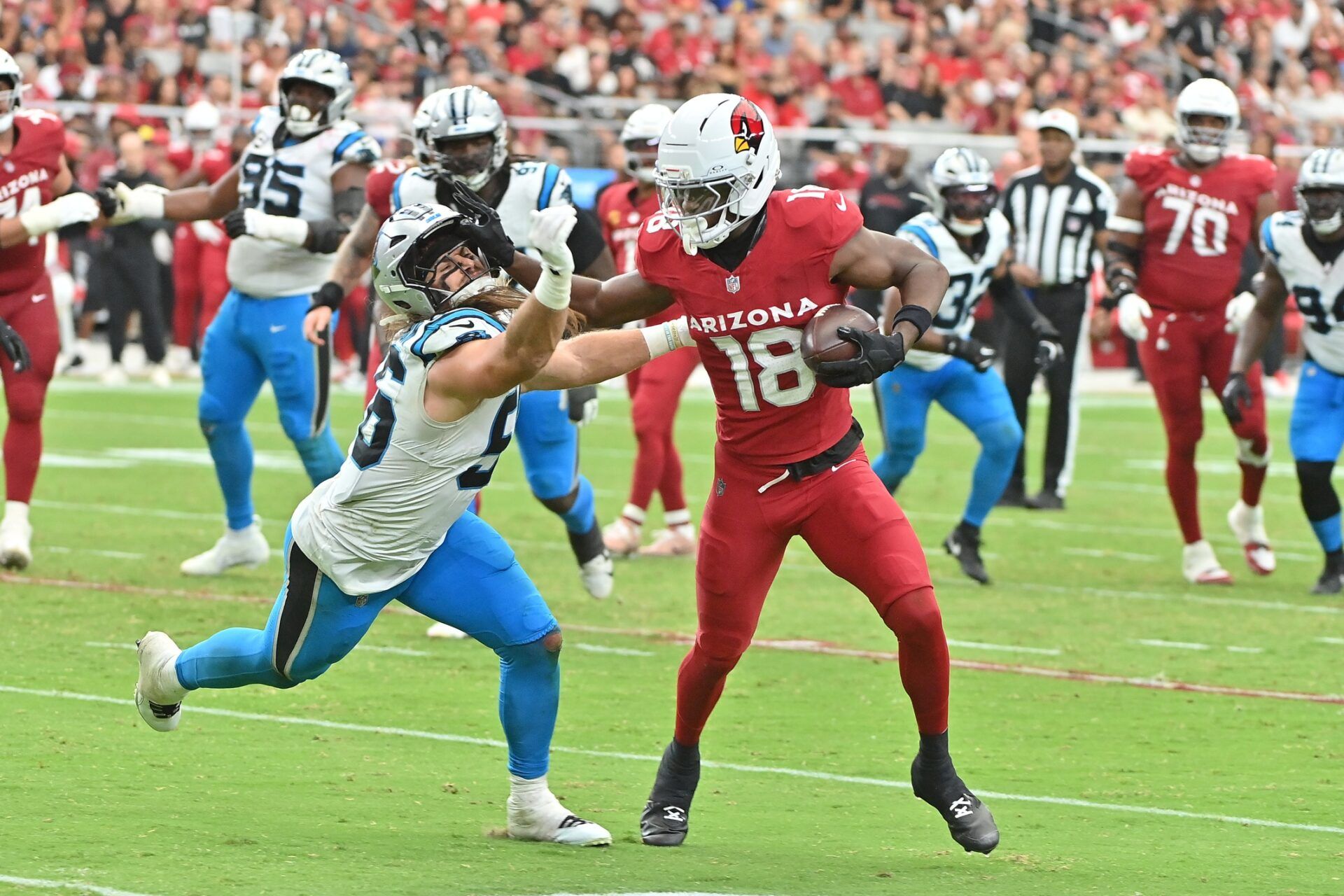 Arizona Cardinals wide receiver Marvin Harrison Jr. (18) runs the ball defended by Carolina Panthers linebacker Christian Rozeboom (56) during the third quarter at State Farm Stadium.
