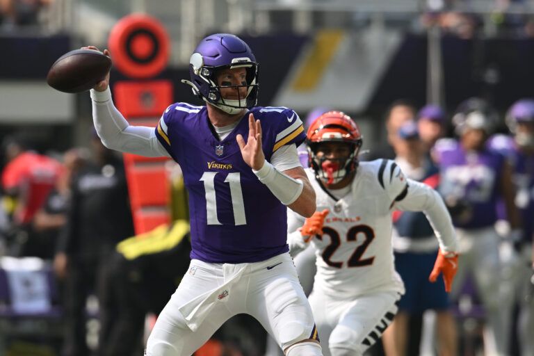 Minnesota Vikings quarterback Carson Wentz (11) throws downfield against the Cincinnati Bengals during the first half at U.S. Bank Stadium.