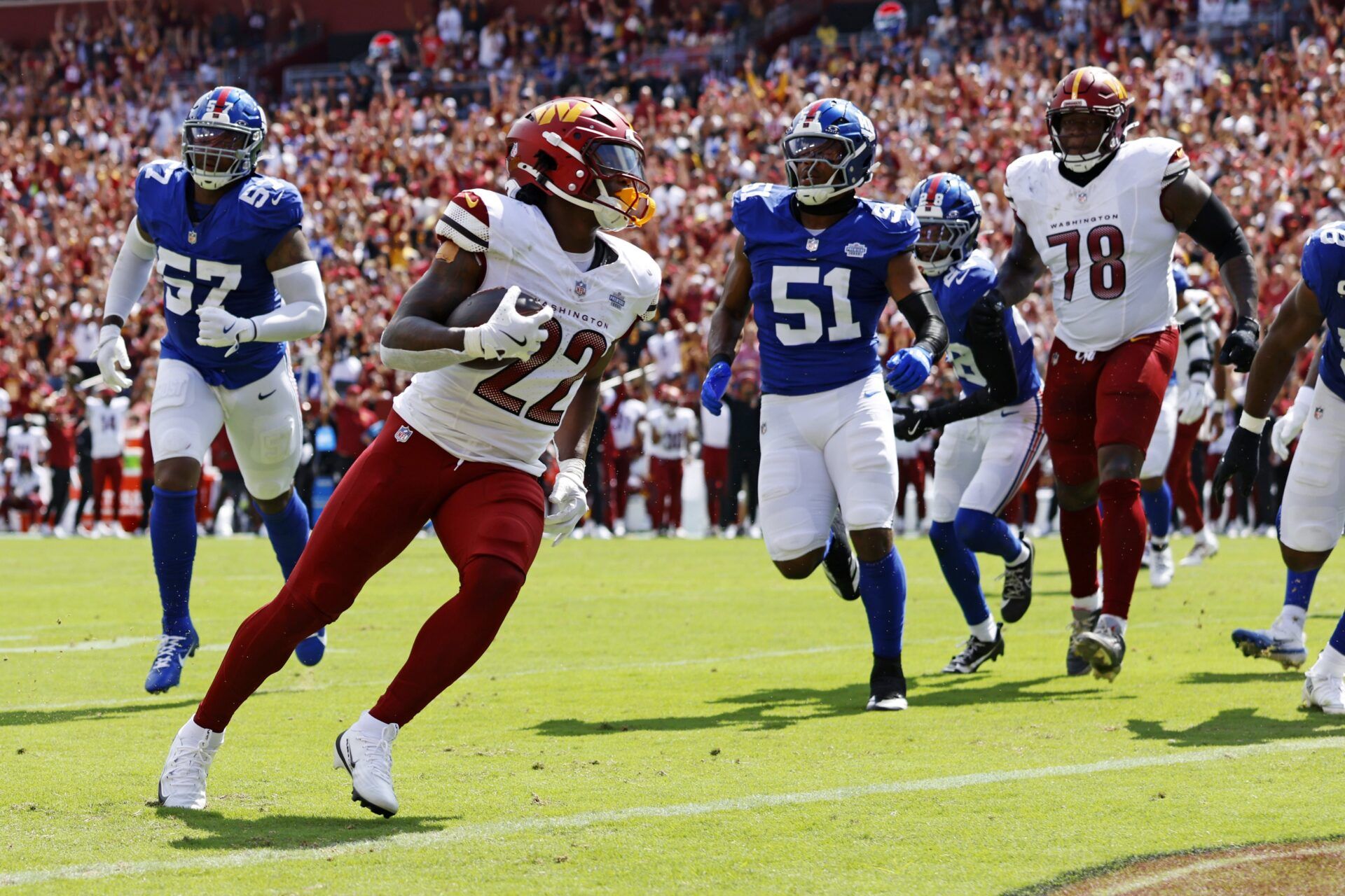 Washington Commanders running back Jacory Croskey-Merritt (22) scores a touchdown during the second quarter against the New York Giants at Northwest Stadium.