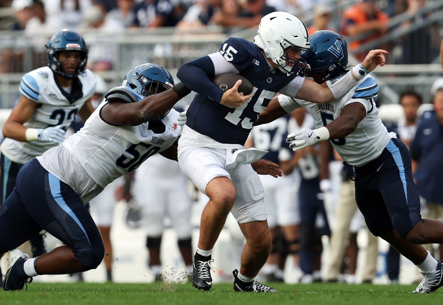 Penn State Nittany Lions quarterback Drew Allar (15) runs with the ball while trying to avoid a tackle during the third quarter against the Villanova Wildcats at Beaver Stadium.