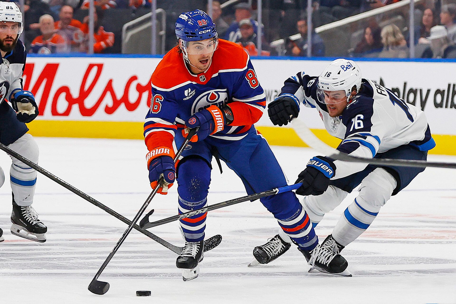 Winnipeg Jets forward Samual Fagemo (16) tries to knock the puck away from Edmonton Oilers forward David Tomasek (86) during the third period at Rogers Place.