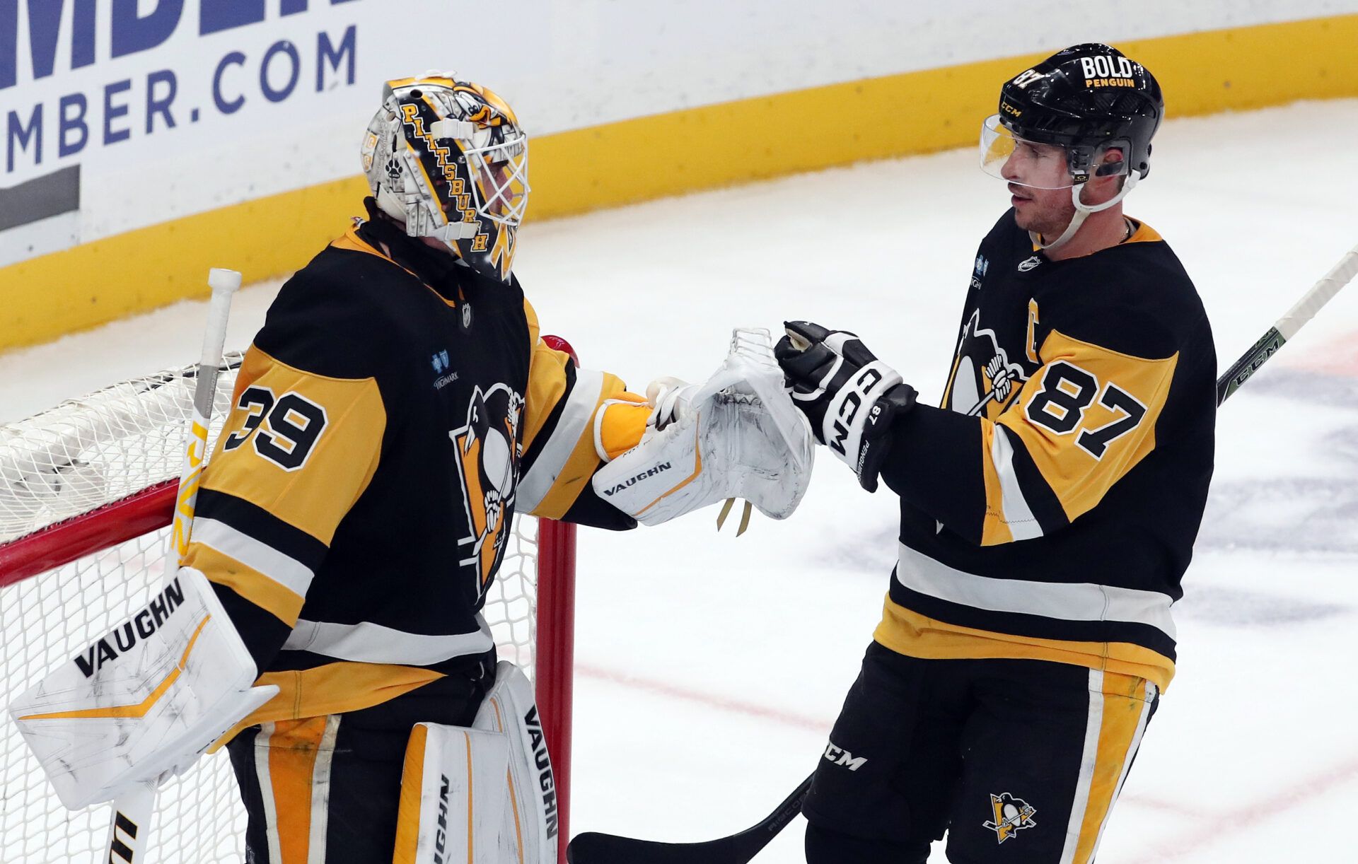Pittsburgh Penguins goaltender Alex Nedeljkovic (39) and center Sidney Crosby (87) celebrate after defeating the Edmonton Oilers at PPG Paints Arena.