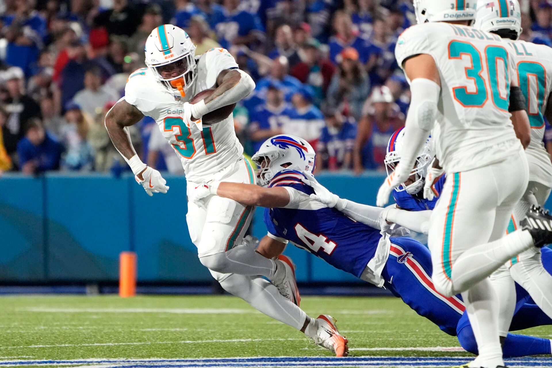 Buffalo Bills safety Cole Bishop (24) tackles Miami Dolphins running back Ollie Gordon II (31) in the fourth quarter at Highmark Stadium.