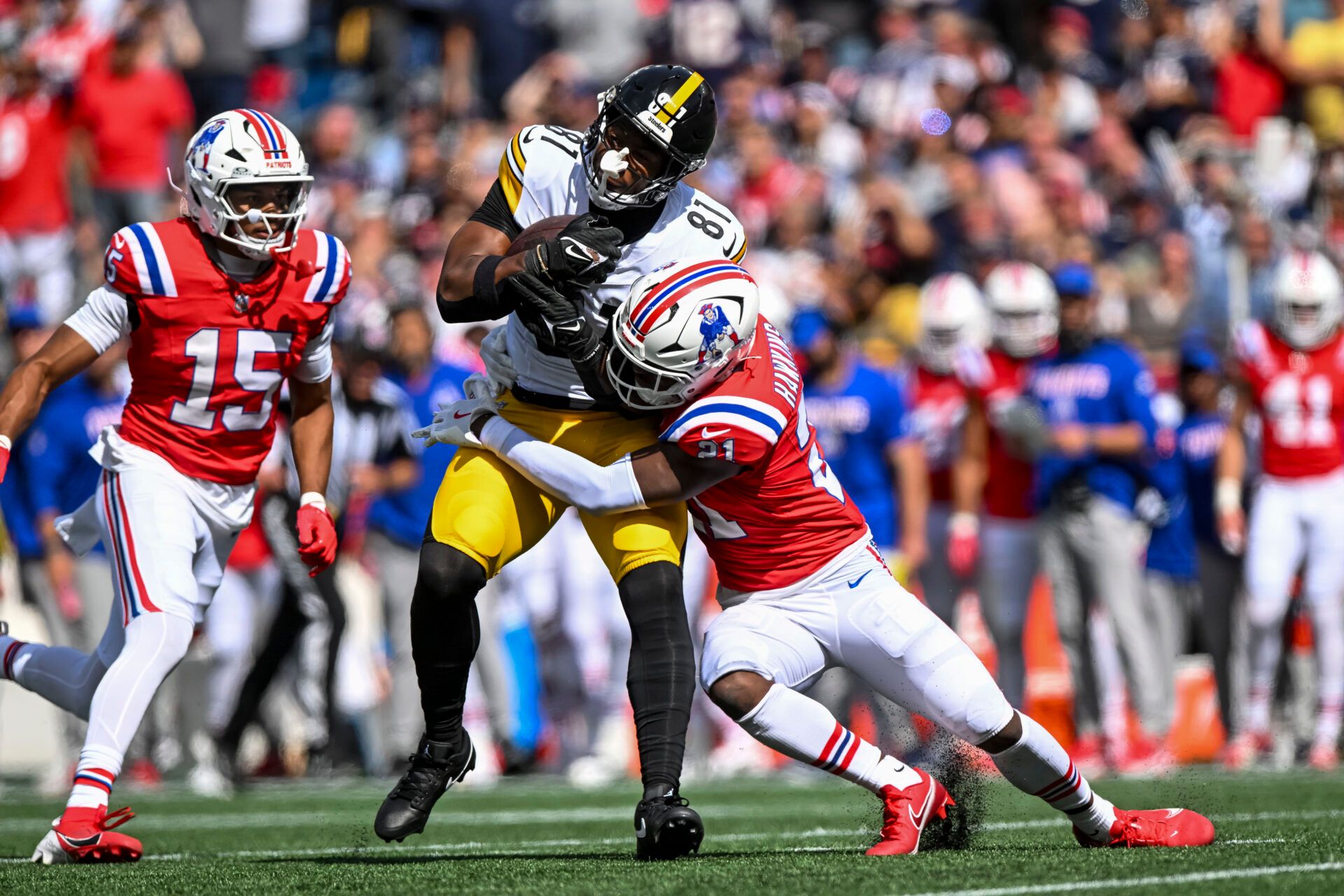 New England Patriots safety Jaylinn Hawkins (21) tackles Pittsburgh Steelers tight end Jonnu Smith (81)during the first quarter at Gillette Stadium.
